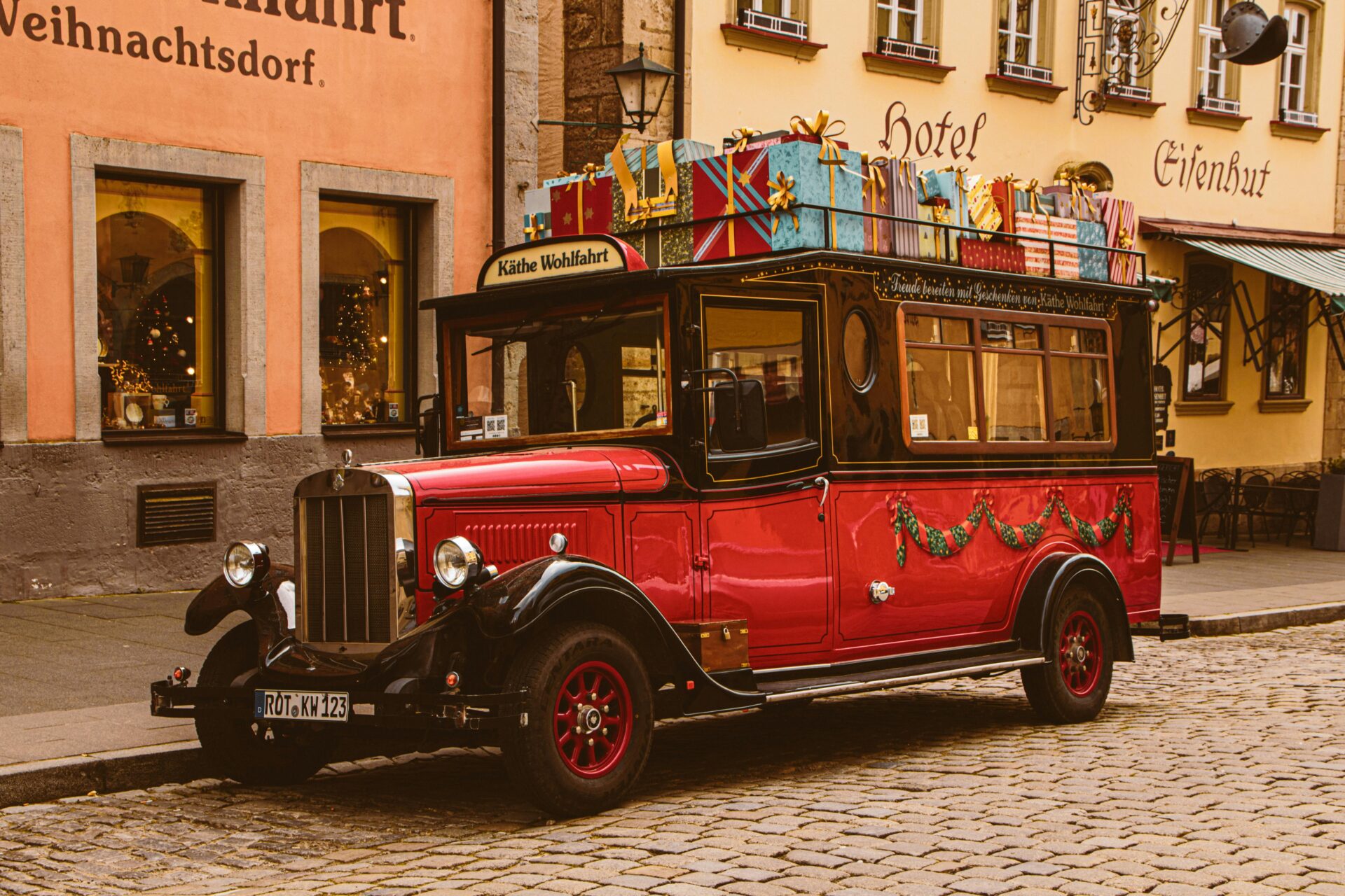 Vintage red Christmas truck parked outside Käthe Wohlfahrt store in Rothenburg ob der Tauber