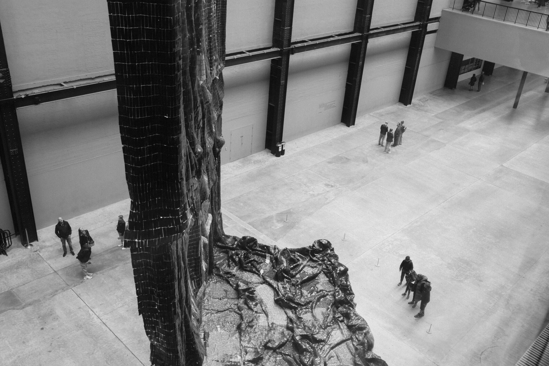 Visitors in Tate Modern’s Turbine Hall viewing Mire Lee’s Open Wound