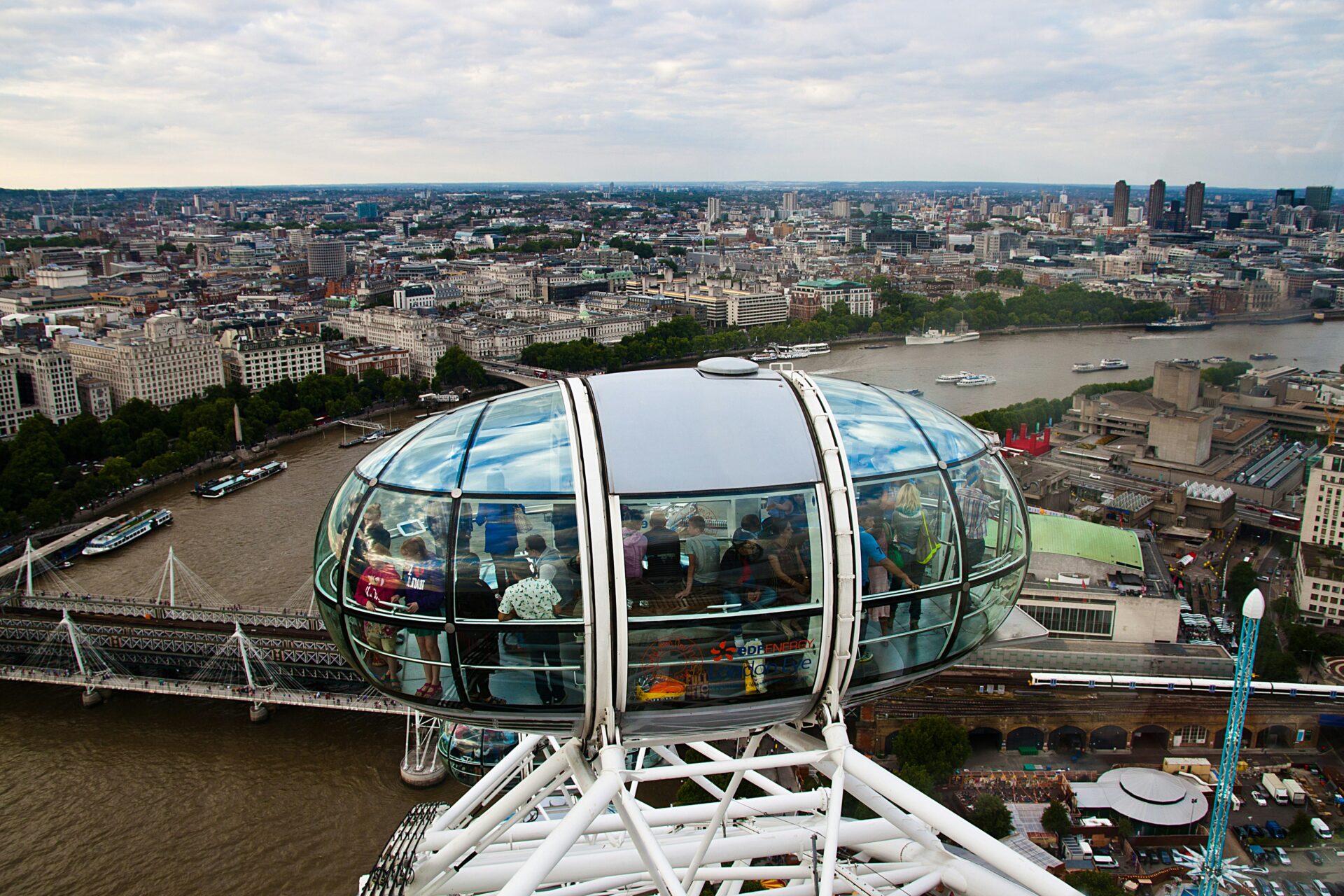 Visitors seated inside a London Eye capsule, looking out over the city
