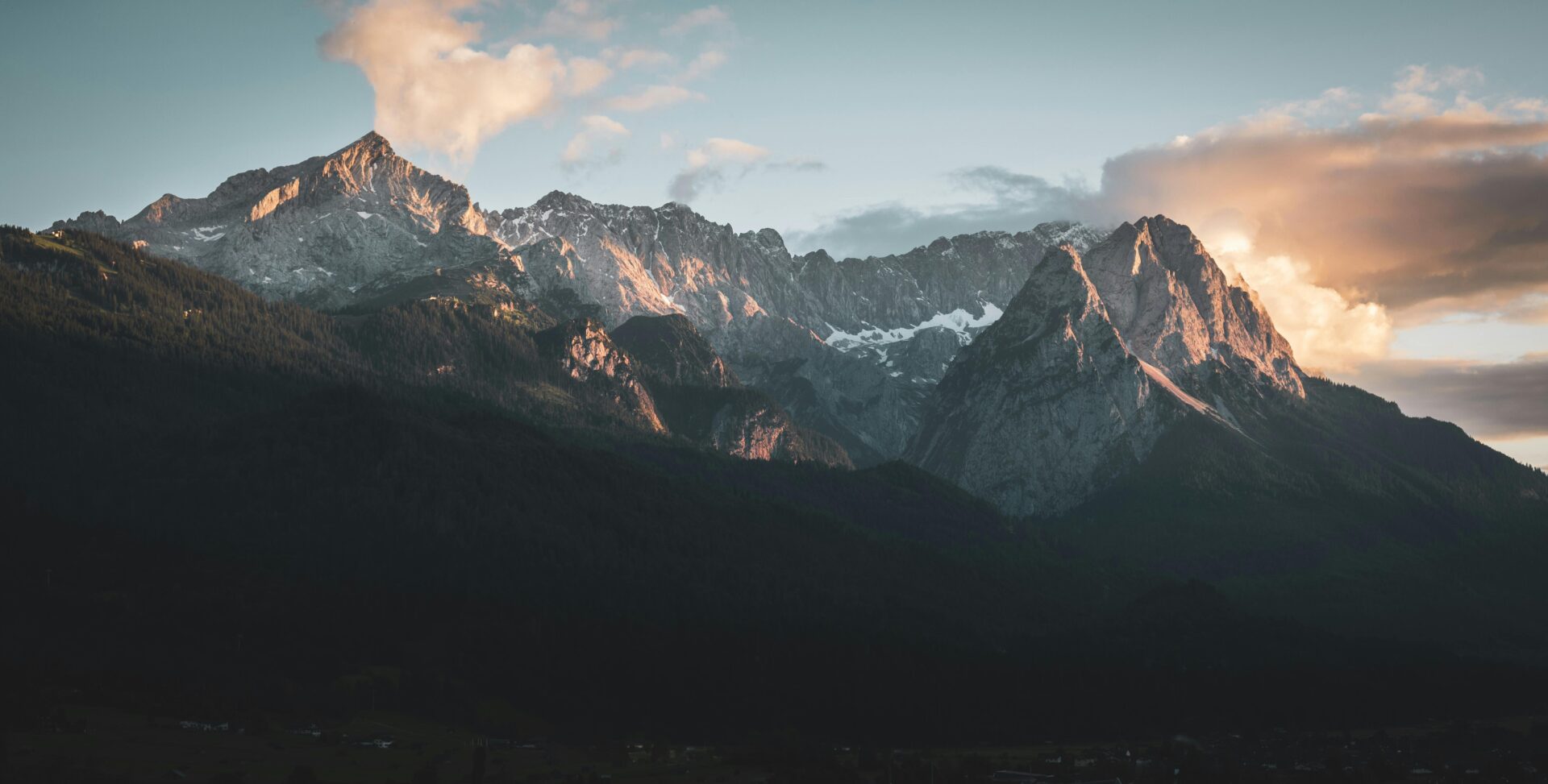 Golden sunlight casting a warm glow on the peak of Zugspitze during sunse
