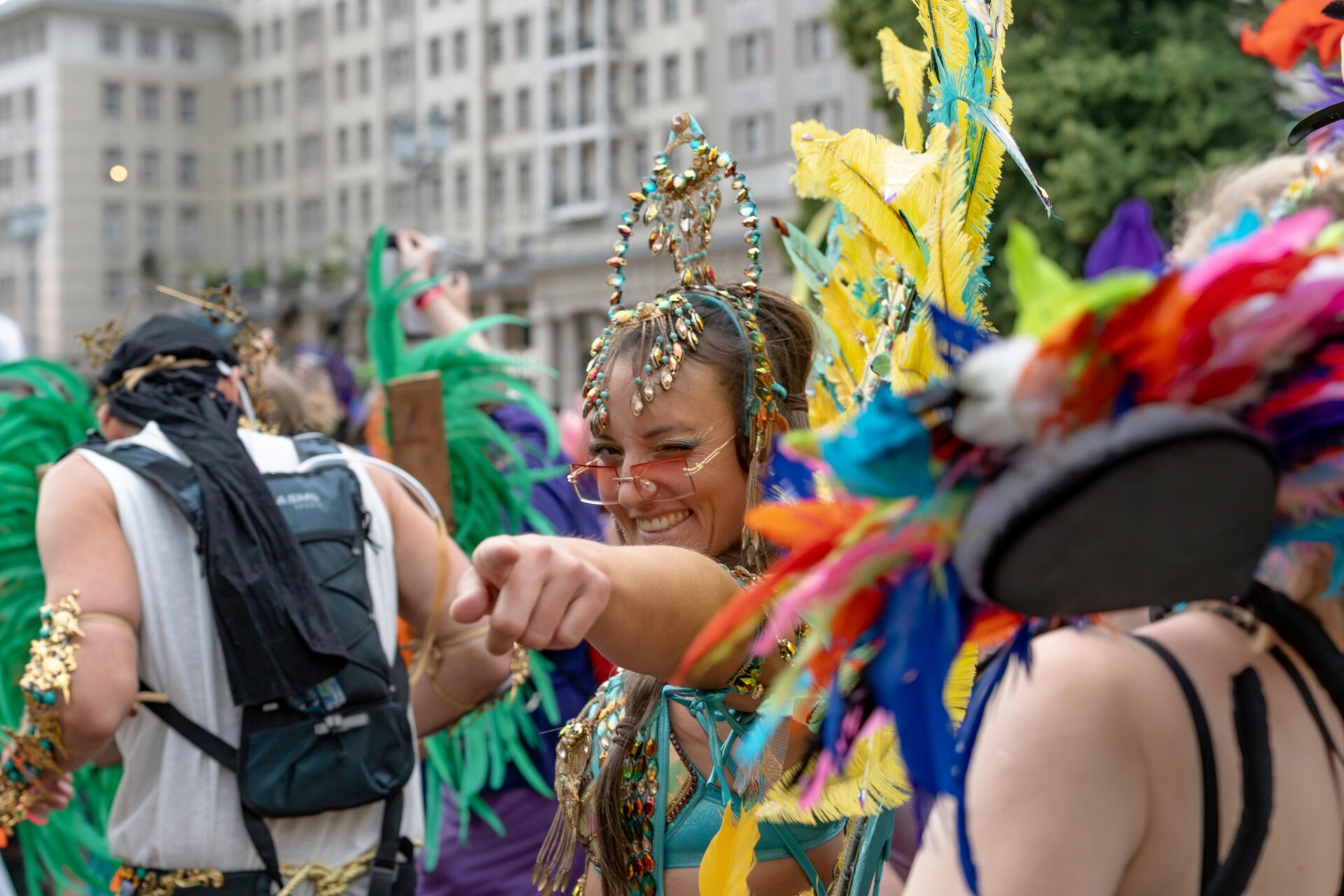 Performers with flags and traditional attire marching in the Carnival of Cultures parade