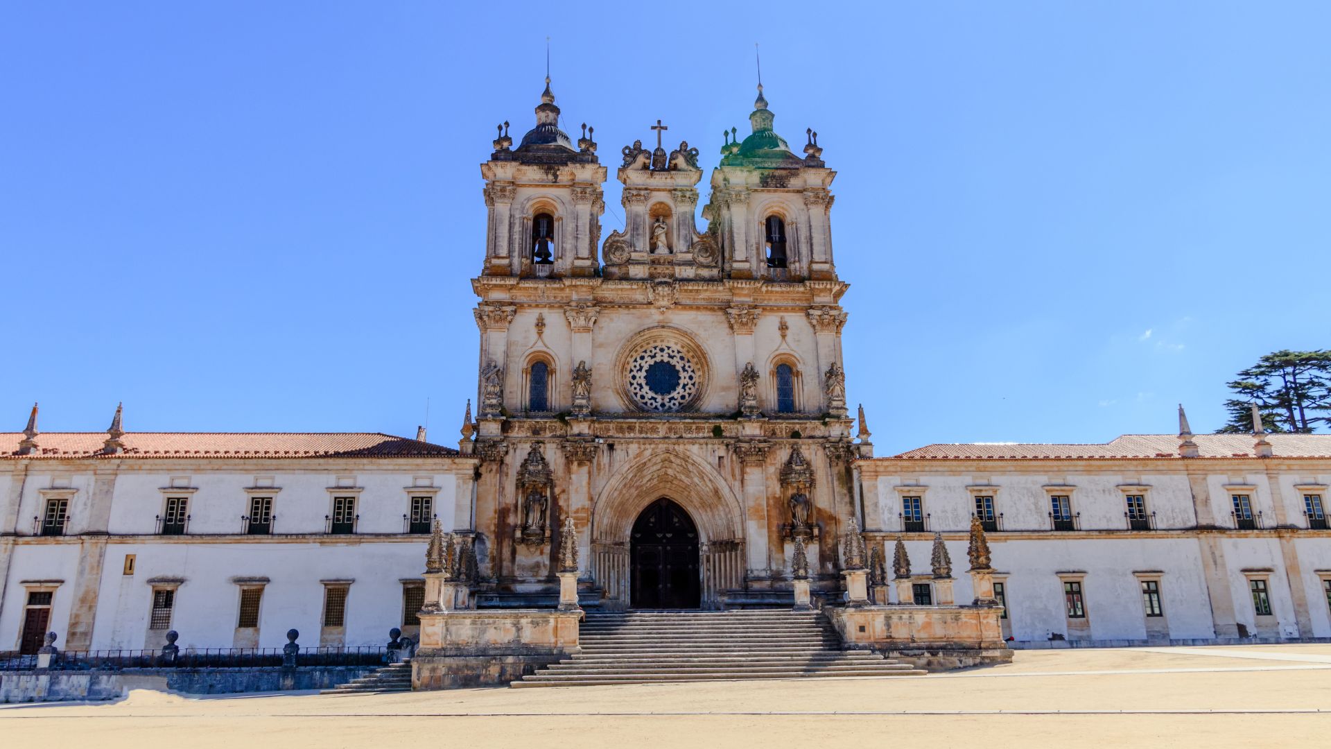 The image displays the Alcobaça Monastery, a significant historical and architectural site located in central Portugal. 