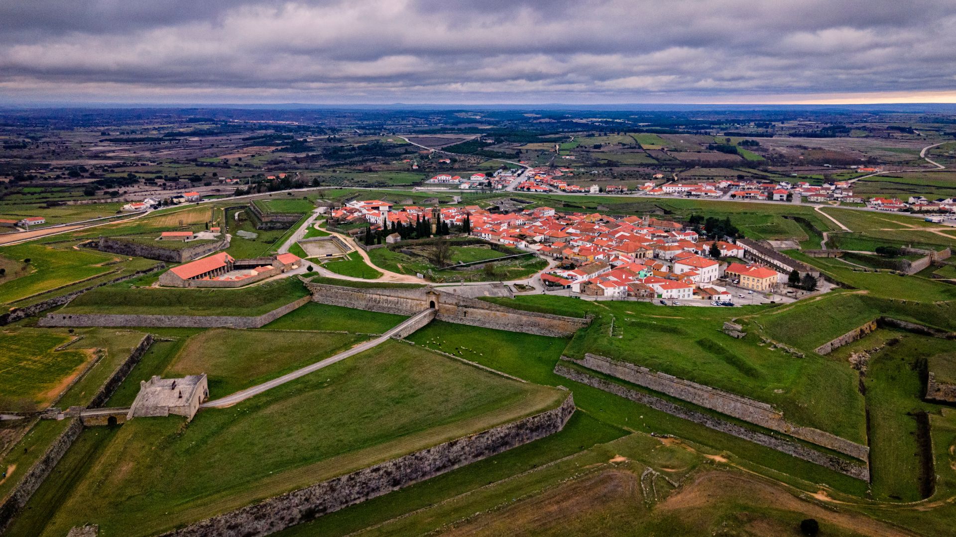Aerial view of the star-shaped fortifications surrounding the historic village of Almeida in Portugal, showcasing its unique Vauban-style design. 