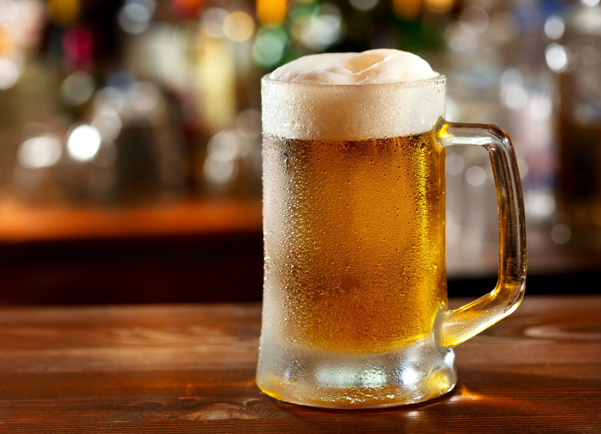 A chilled glass of golden beer with a foamy head