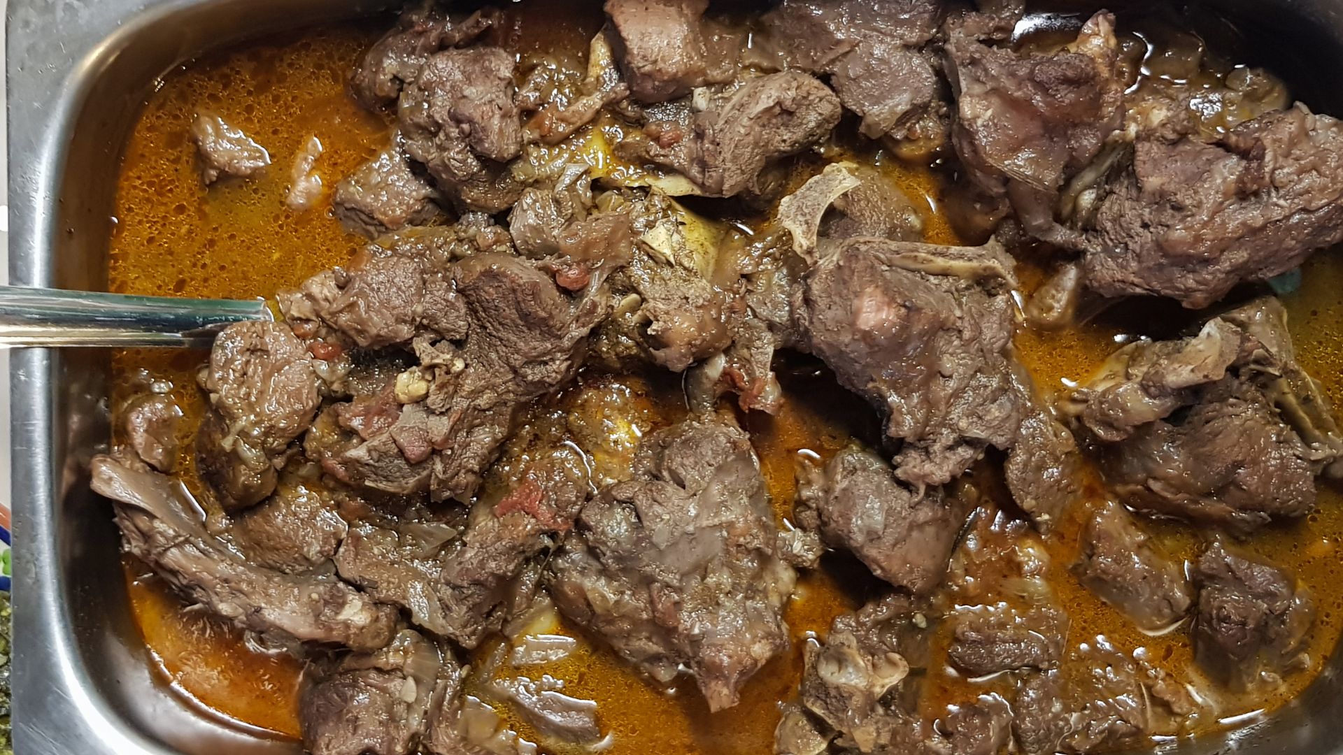 Slow-cooked goat stew with red wine,