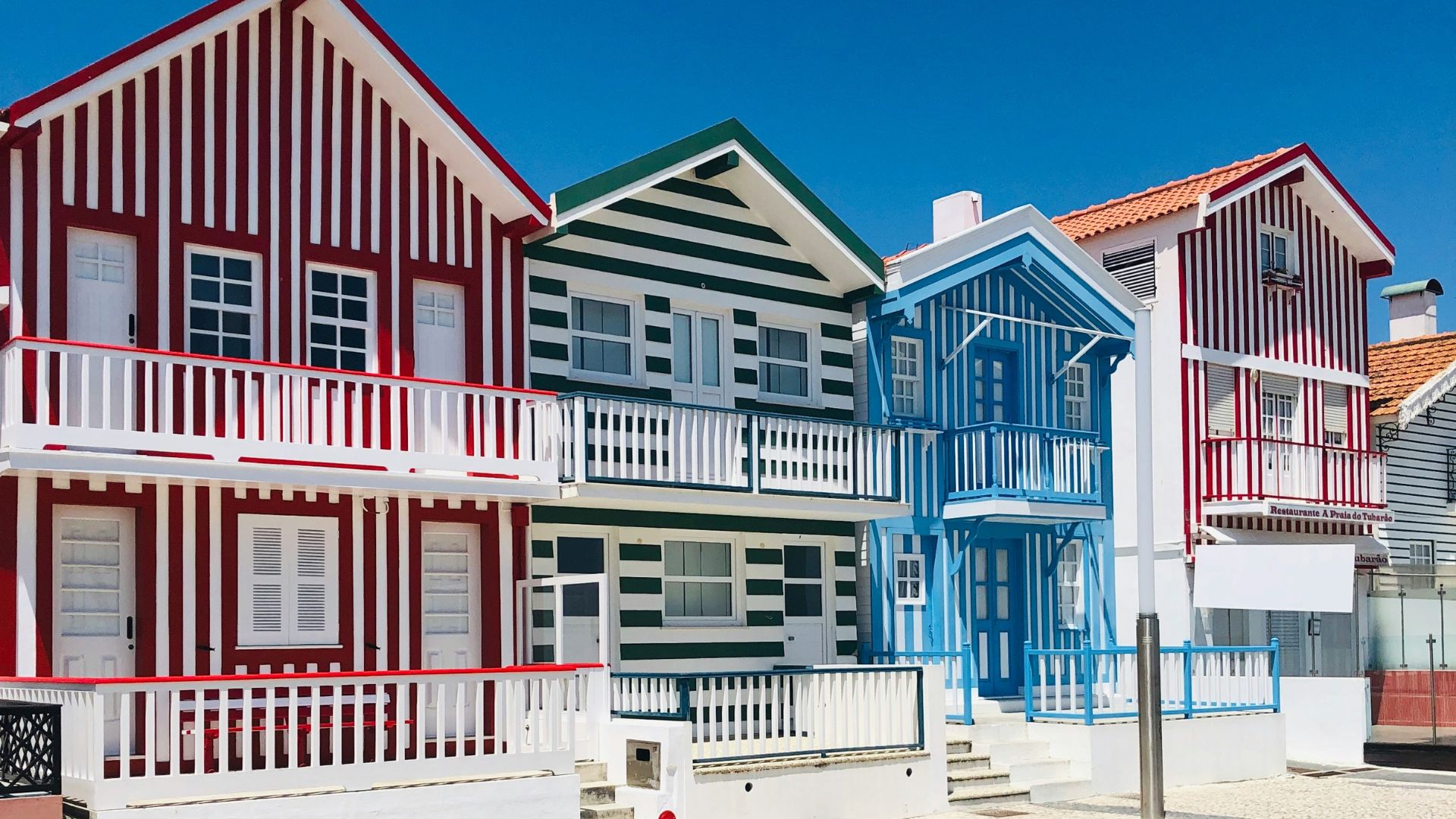 Iconic colorful striped houses (palheiros) of Costa Nova, a charming seaside village in Aveiro, Portugal.