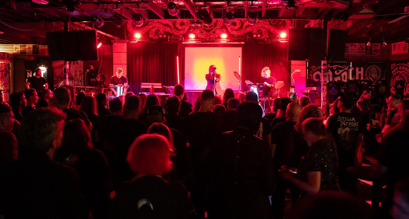 Dimly lit concert crowd inside Crowbar