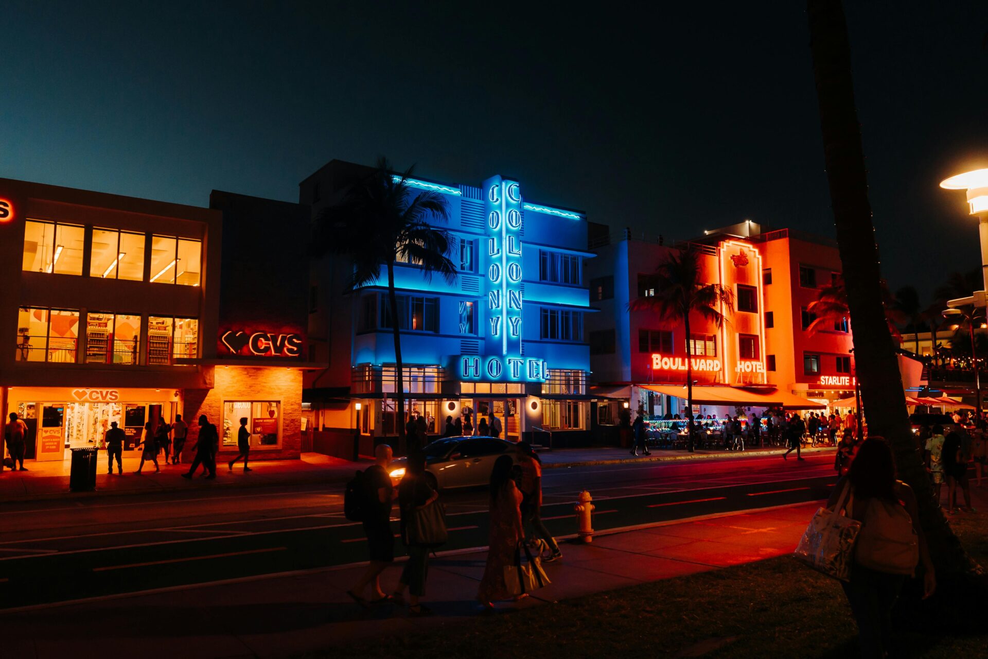 Ocean Drive at night with historic Art Deco hotels glowing in vibrant neon lights