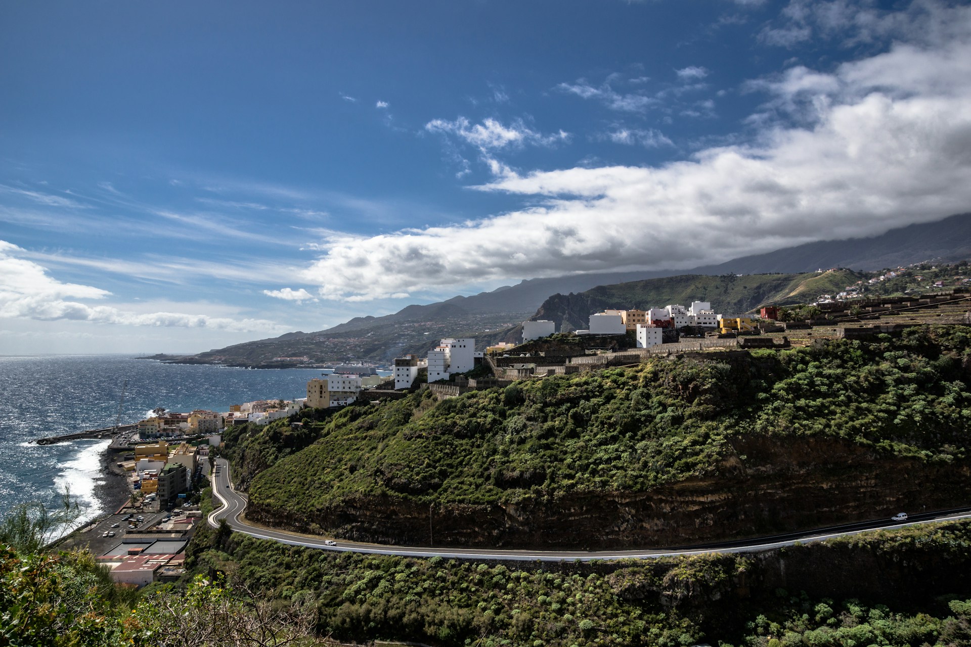 Colorful houses perched on cliffs overlooking the ocean in a small village on La Palma’s northern coast.