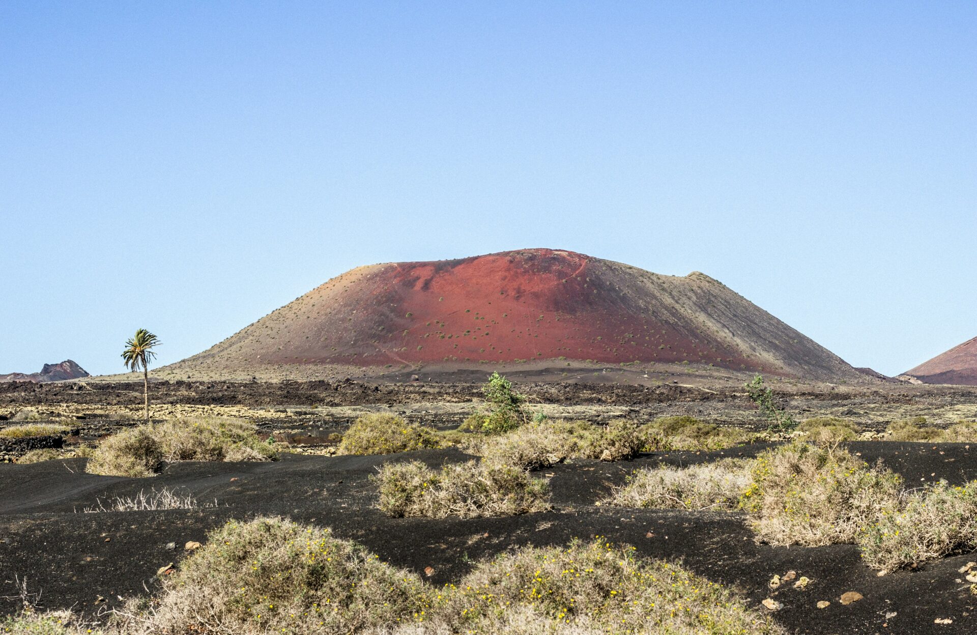 A volcanic cone rising from the barren lava fields of Lanzarote 