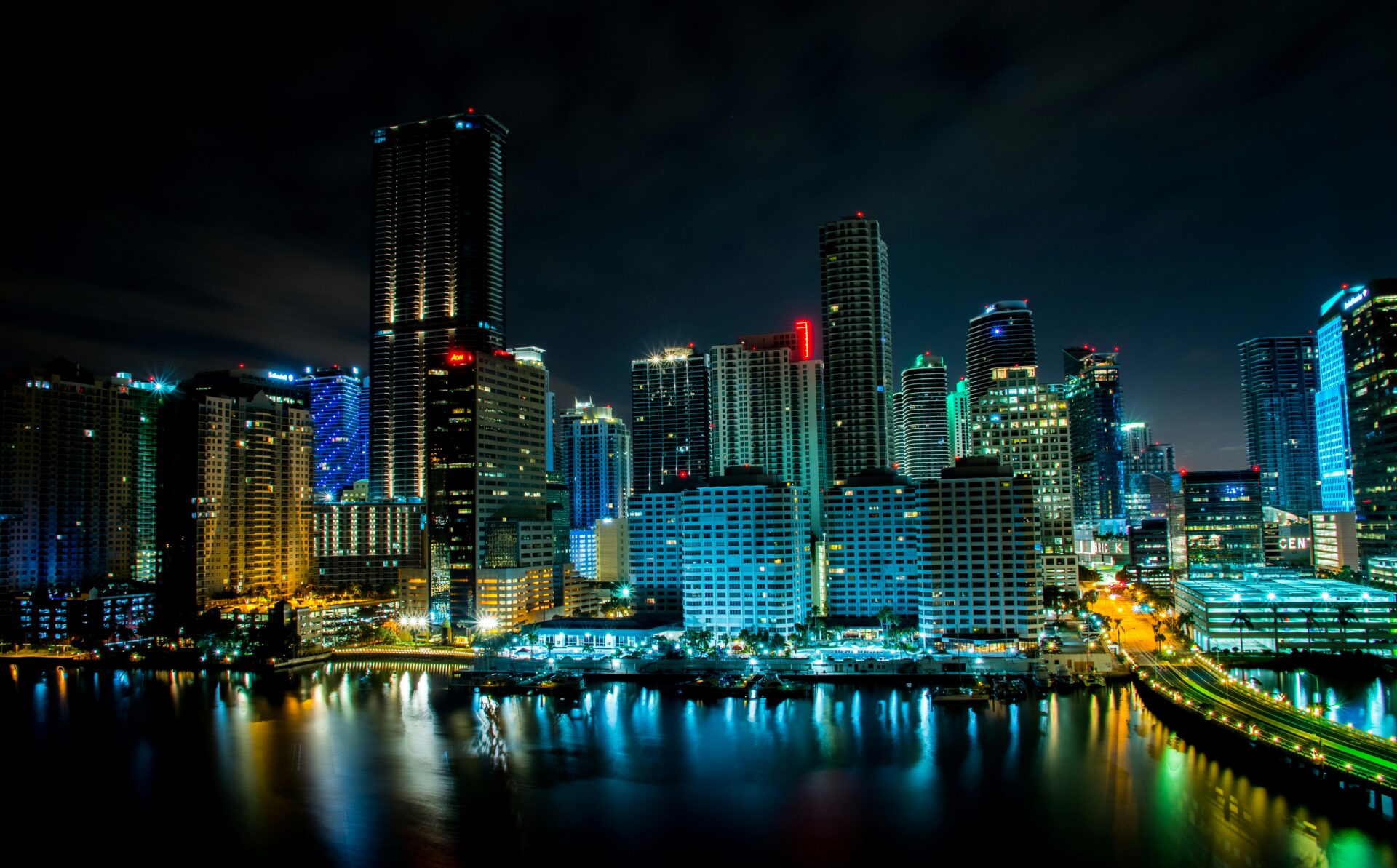 A nighttime view of Miami with illuminated high-rise buildings