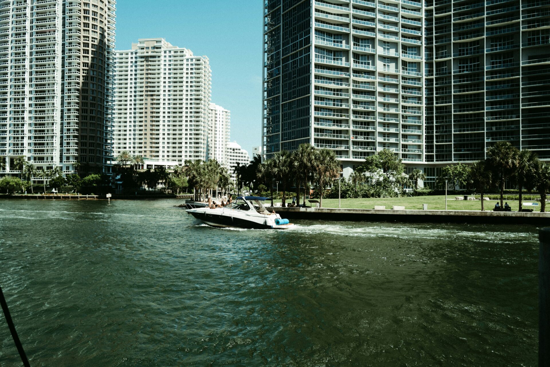 Motorboat on Miami Bay passing by waterfront buildings