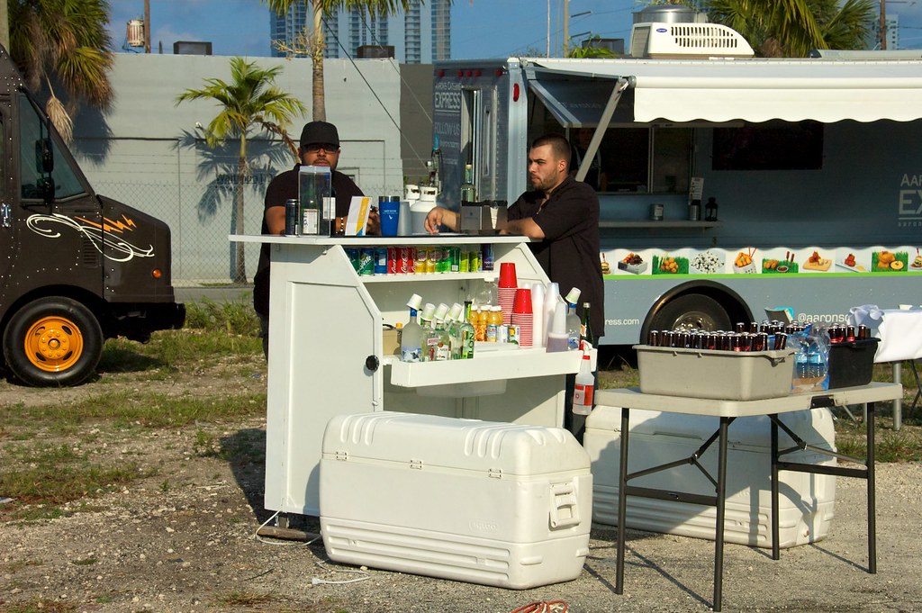 A vibrant food truck parked on a bustling city street of Miami