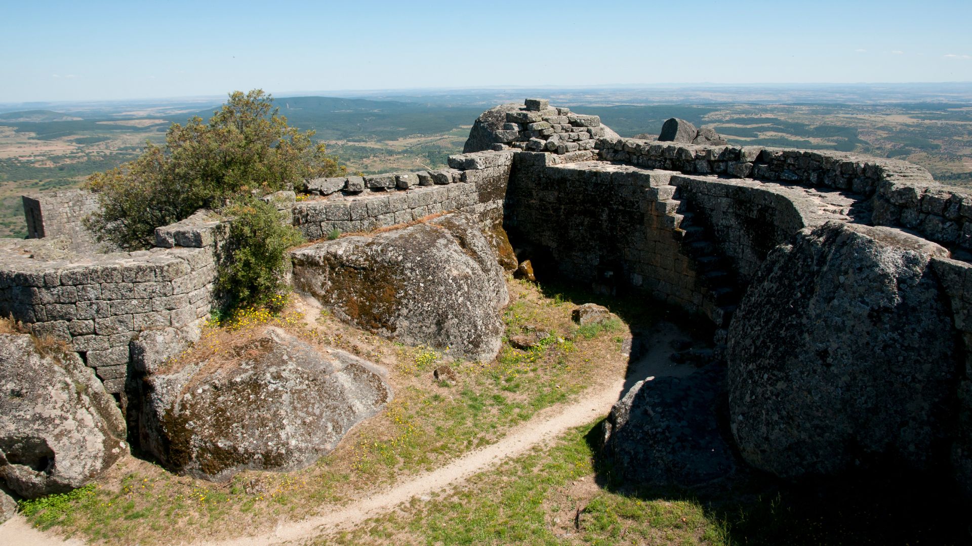 Medieval ruins of the Castle of Monsanto, a mountaintop castle in Monsanto, Portugal, with a view of the surrounding landscape. 