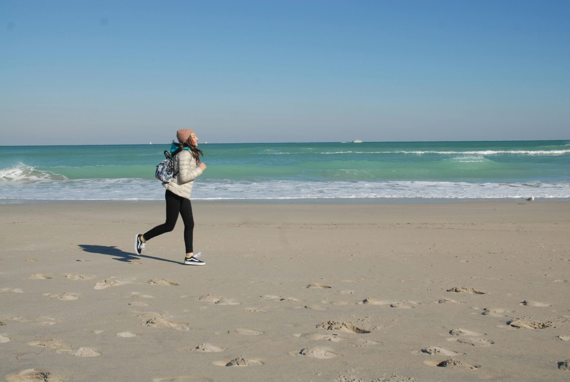 A person jogging along the shoreline of Miami Beach