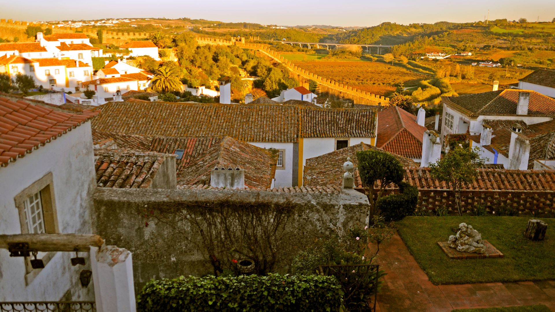 Distinctive rooftops and buildings, and the prominent medieval walls that encircle the historic town. 