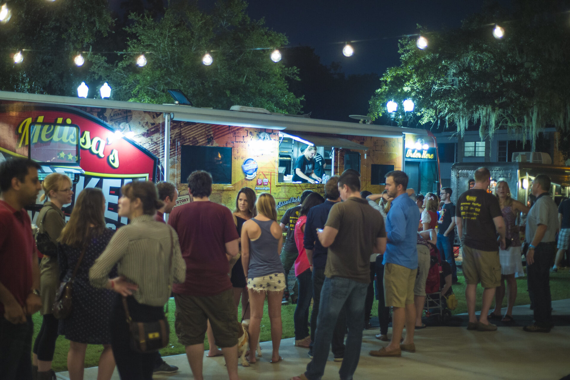 Families and friends gathered around several food trucks at an Orlando 