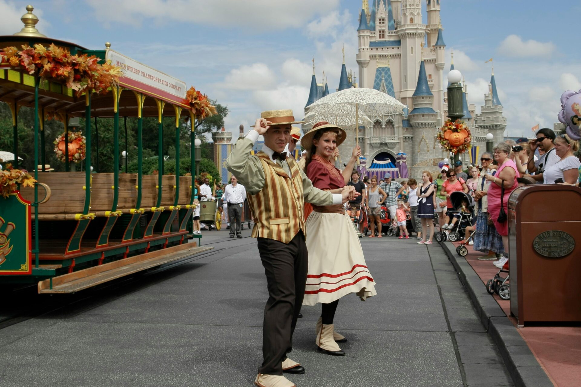 A group of excited Disney fans dressed in elaborate costumes