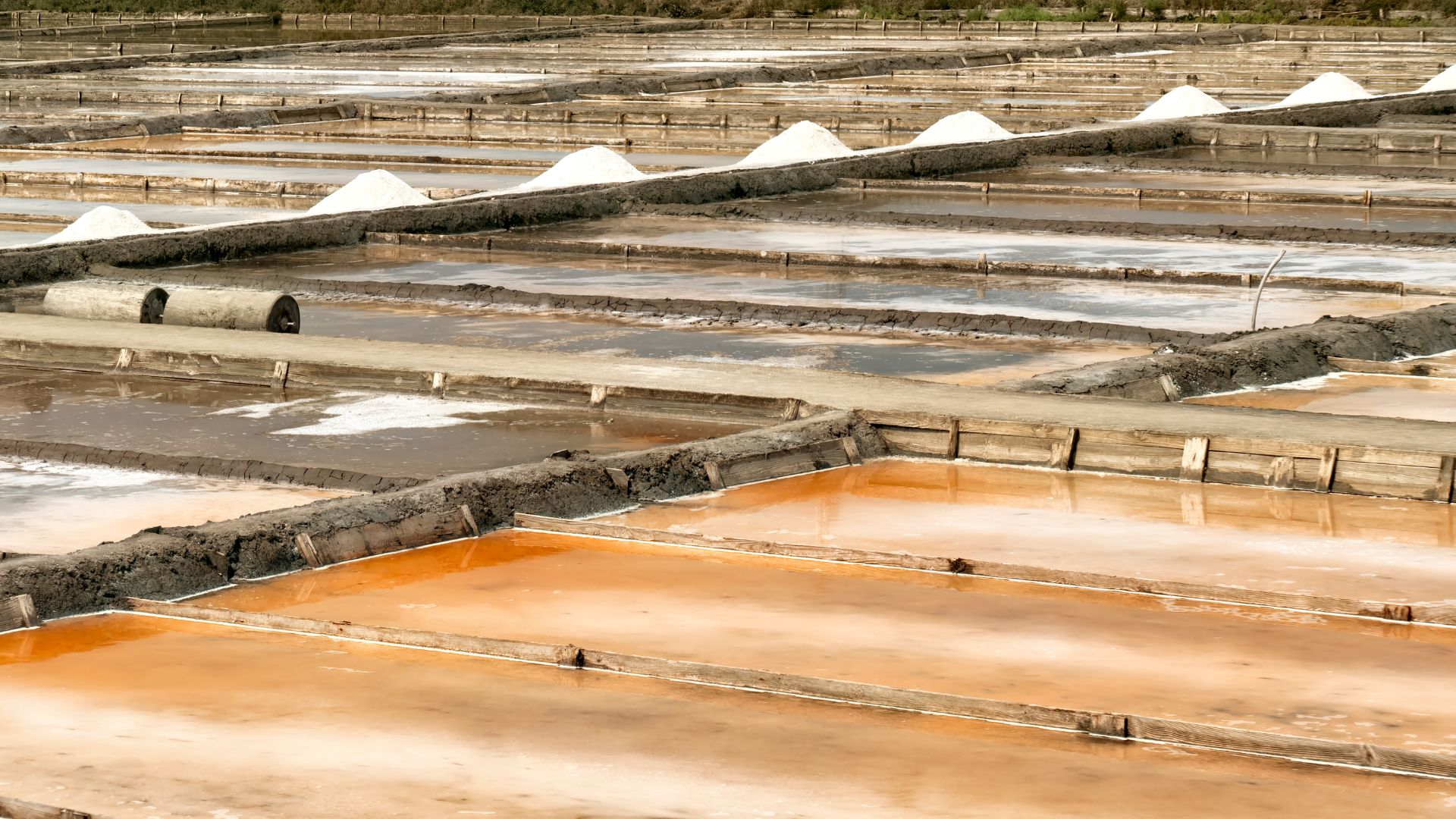 Artisanal salt pans in Portugal, where salt is traditionally harvested from the sea through evaporation.