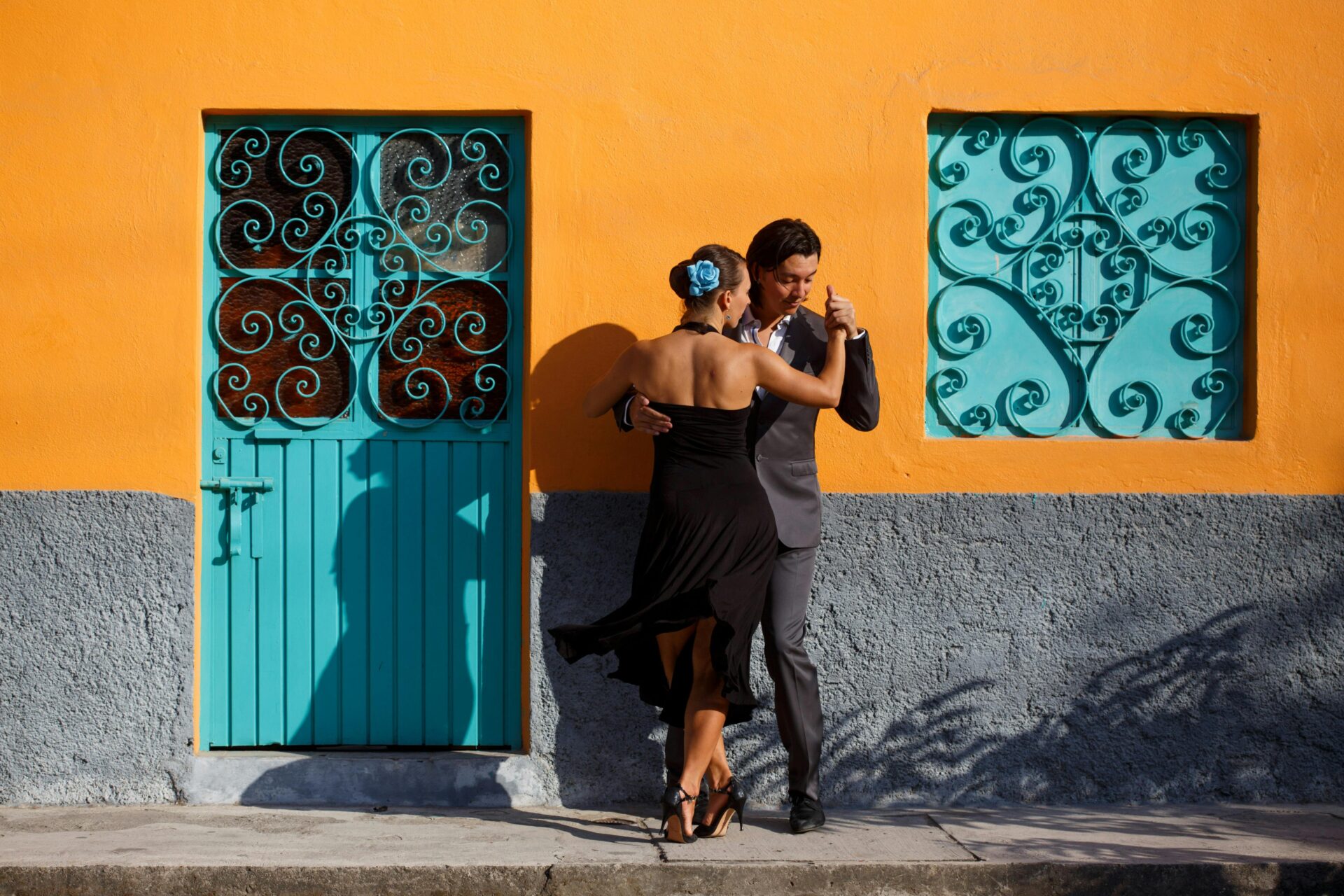 A couple dancing salsa on a lively Miami street,