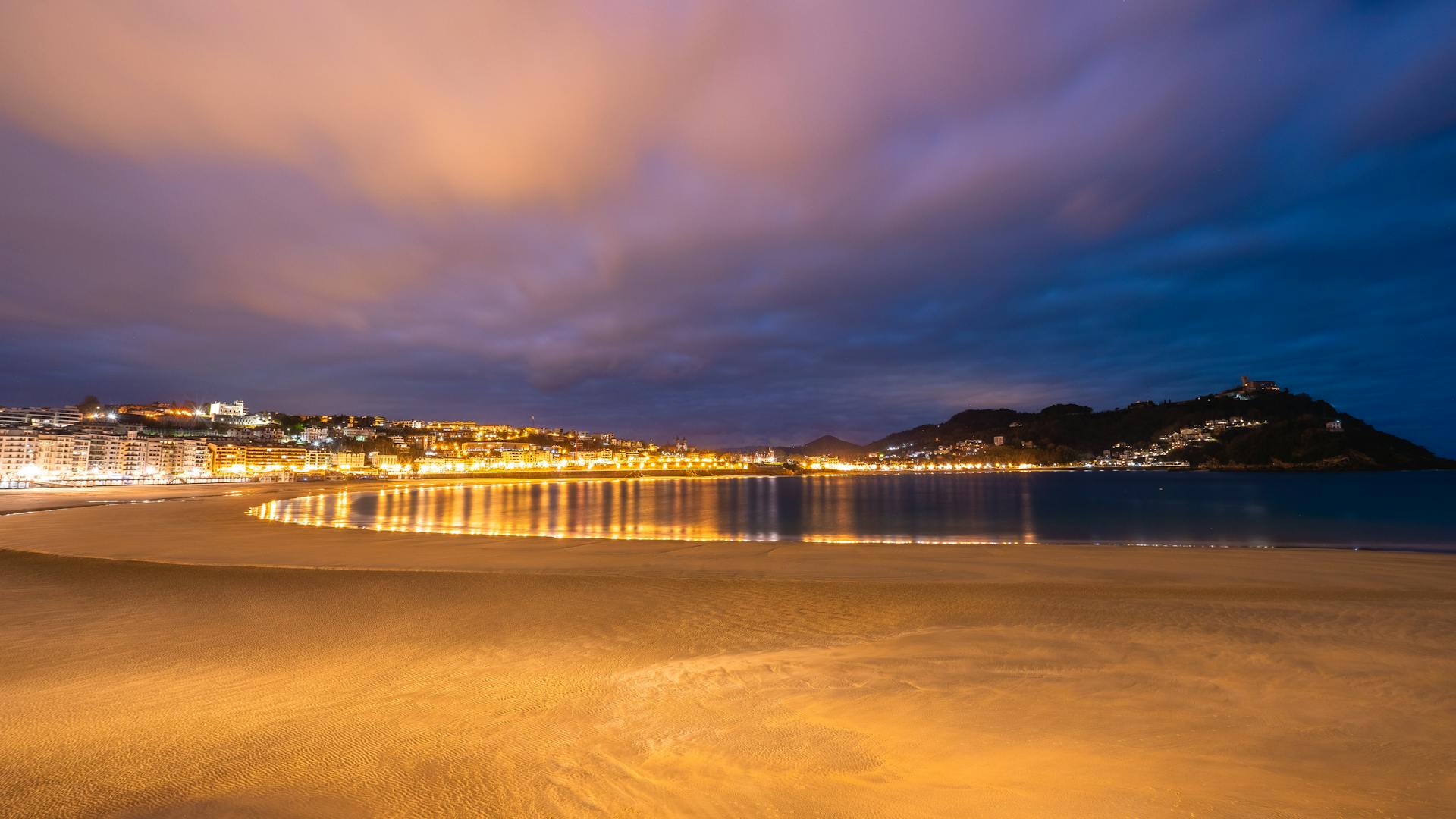 San Sebastián de La Gomera glowing with warm city lights along the coast