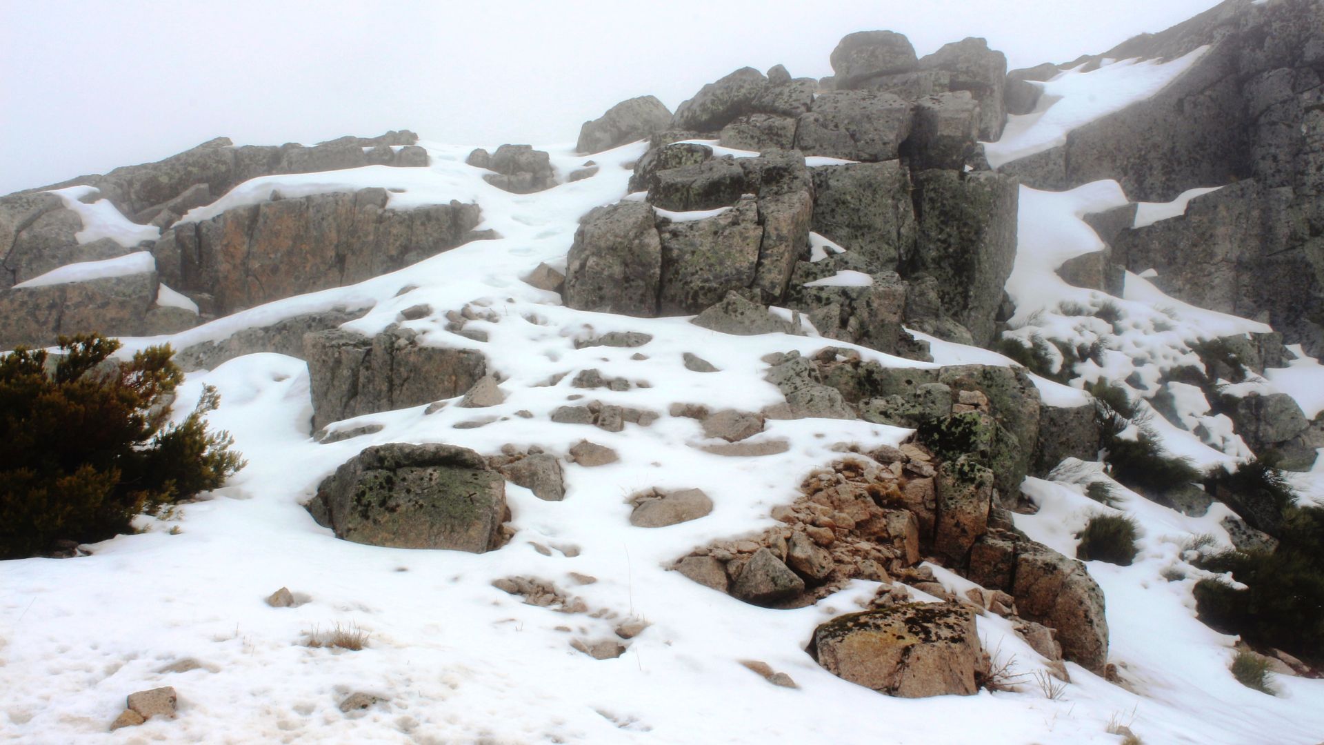 A serene winter landscape showcasing the majestic, snowy Serra da Estrela in Portugal