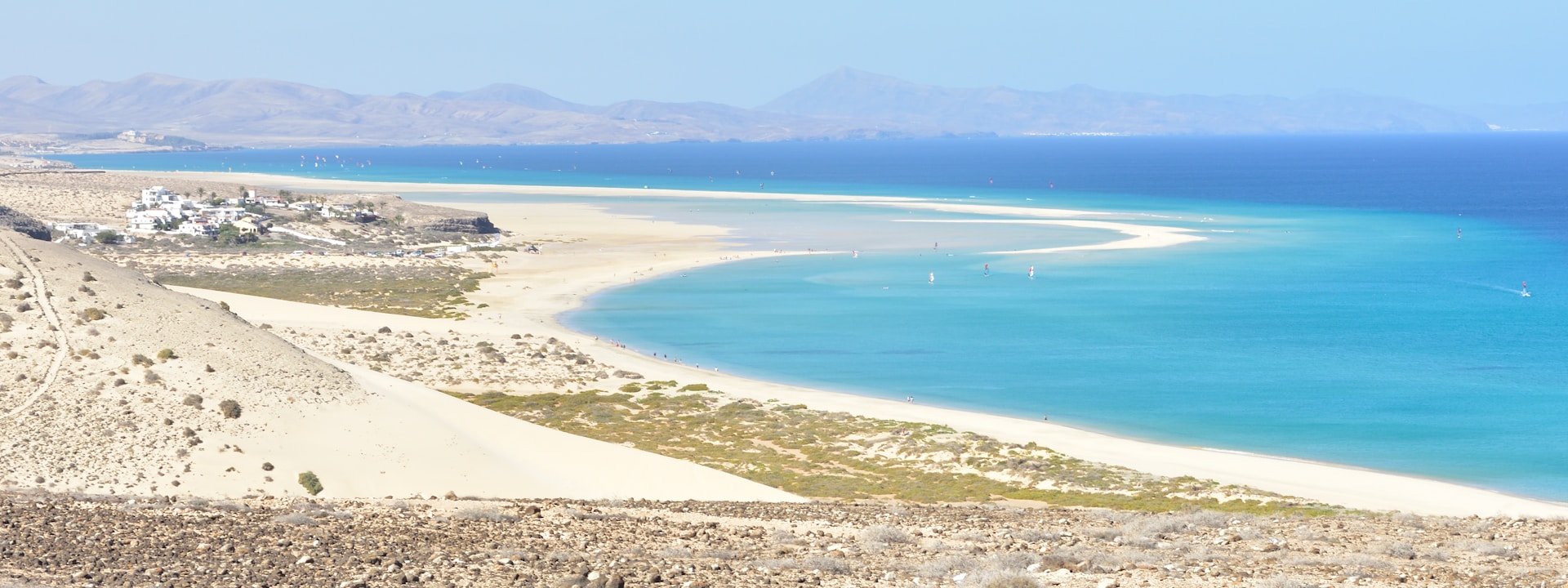 Shallow tidal lagoon at Sotavento Beach reflecting the sky