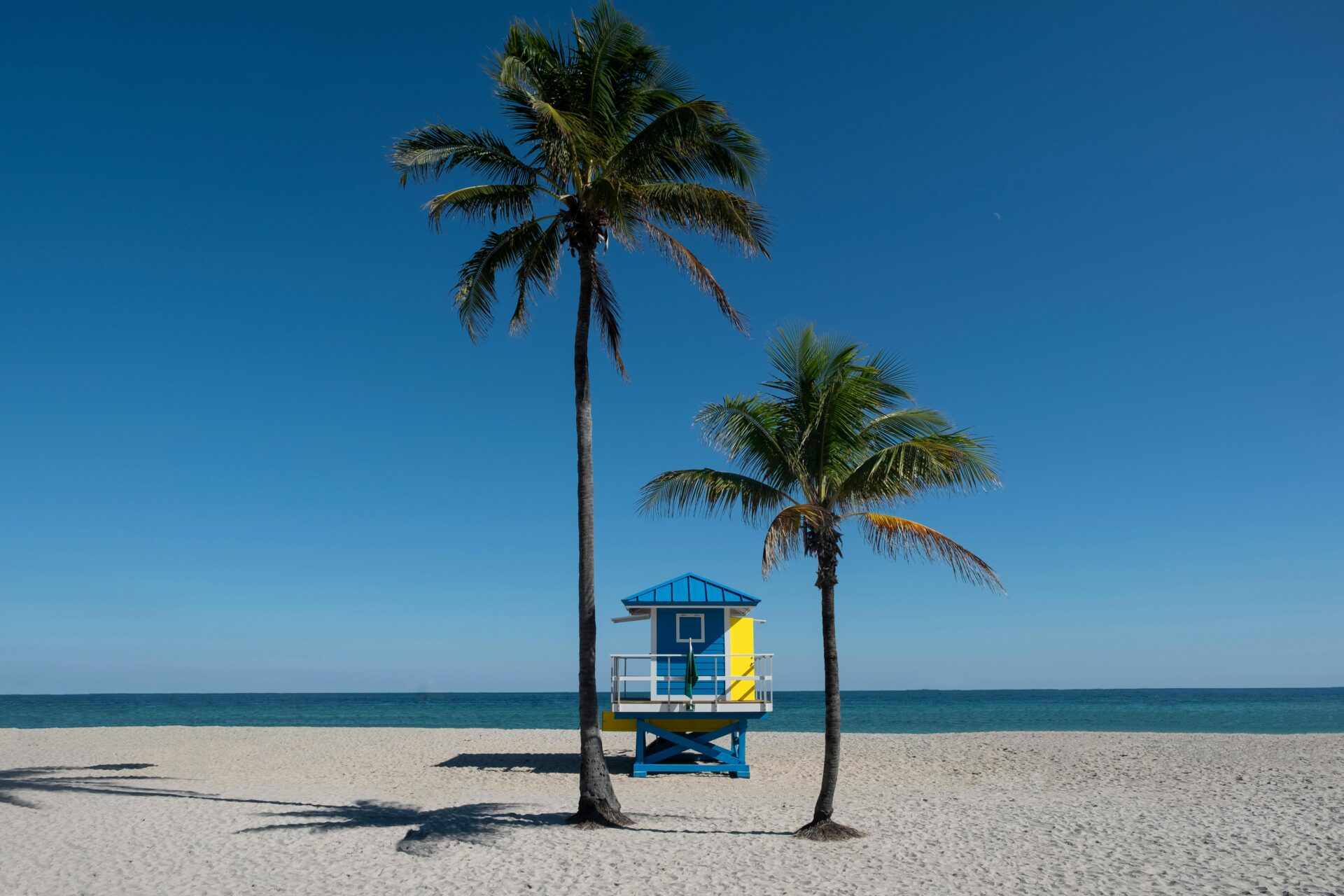 A sunny South Beach scene featuring a vibrant lifeguard house