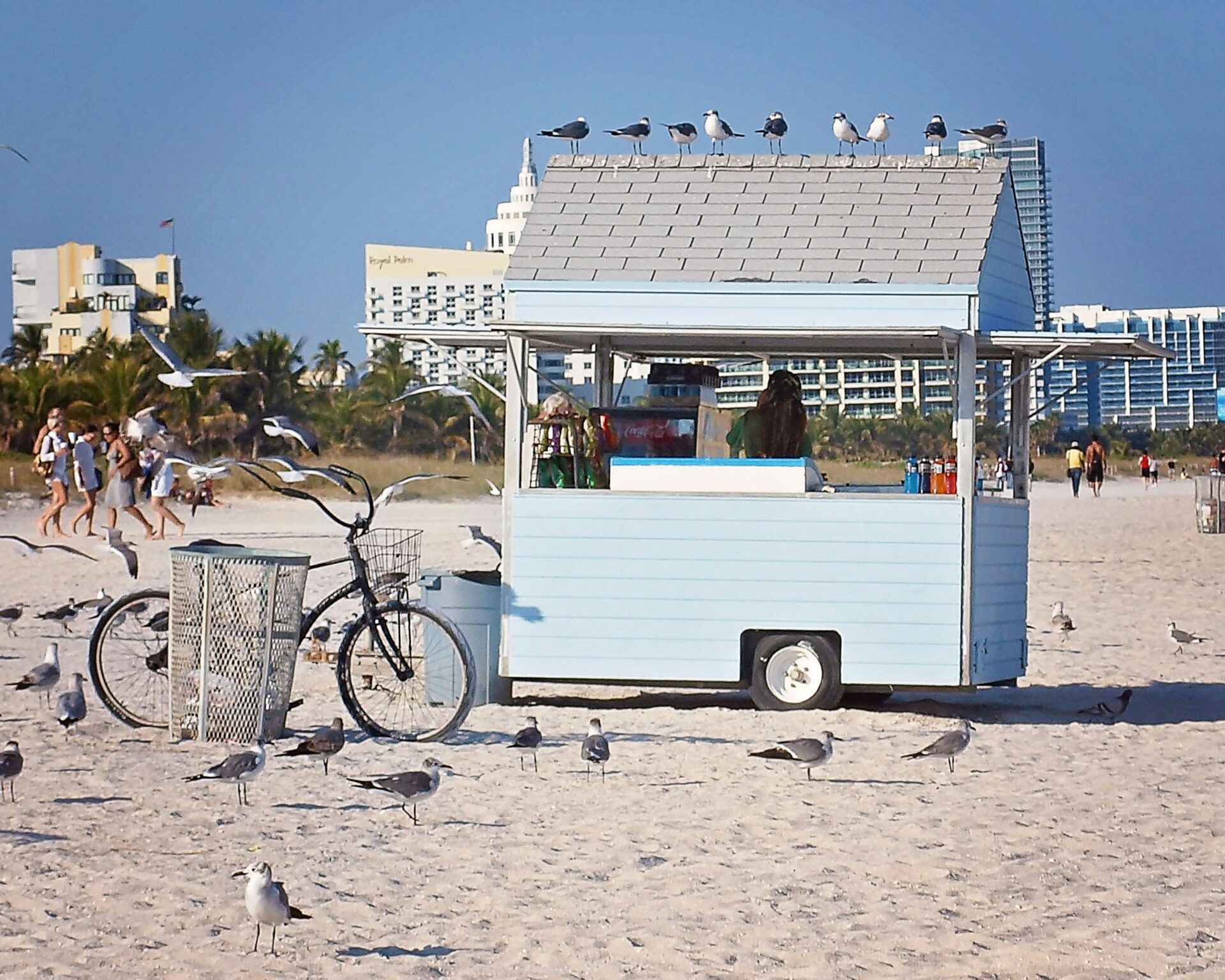 A colorful food truck parked on the soft sands of South Beach
