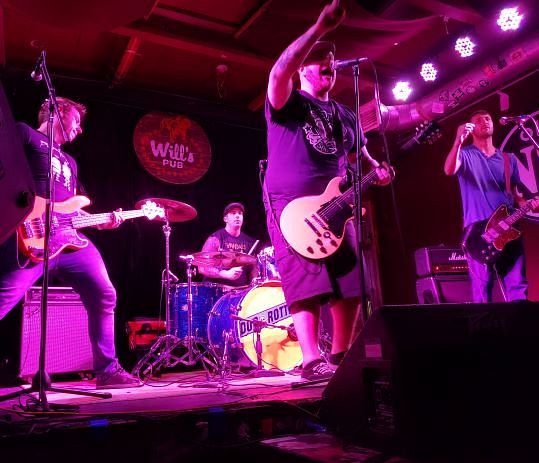 A performer on stage at Will's Pub in Orlando