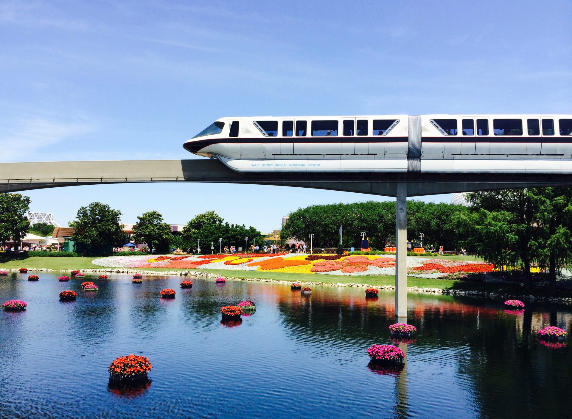 Futuristic high-tech train passing over a river bridge near Epcot in Orlando