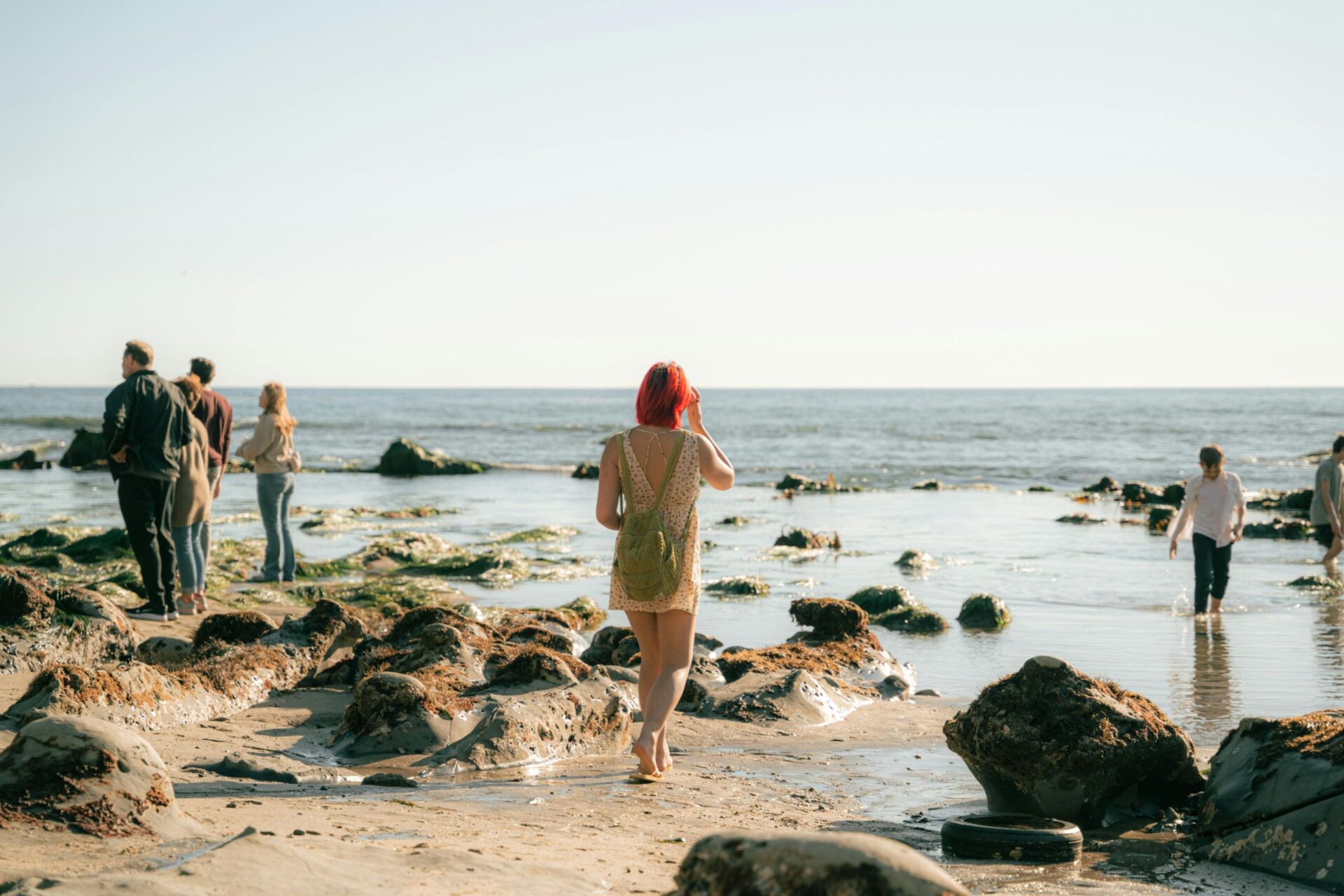 woman walking on rocky beach