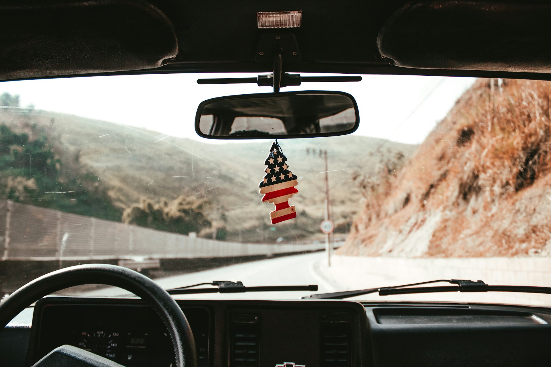 Vintage cars driving along the historic Route 66 in the American Southwest.