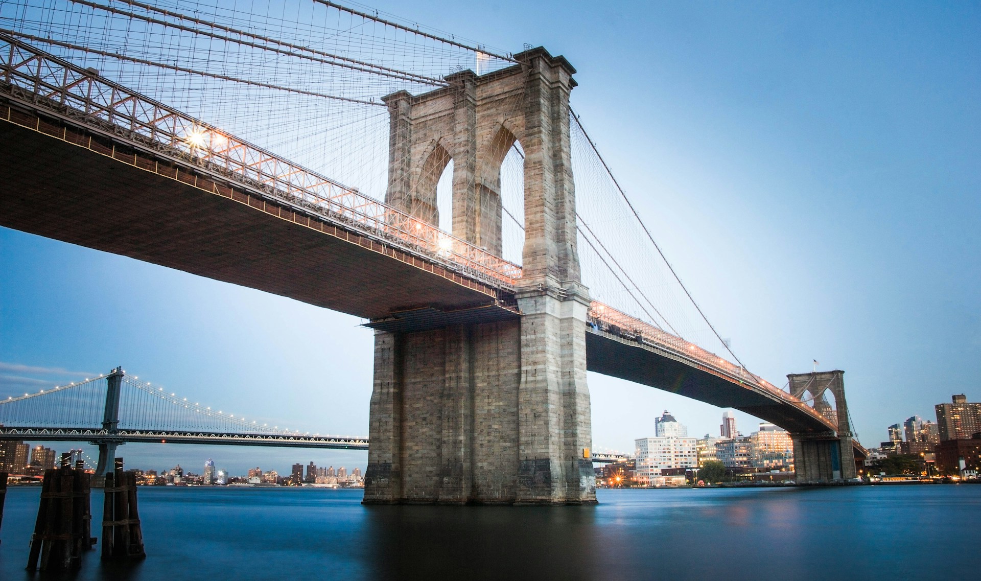 The Brooklyn Bridge spanning the East River, connecting Manhattan and Brooklyn.