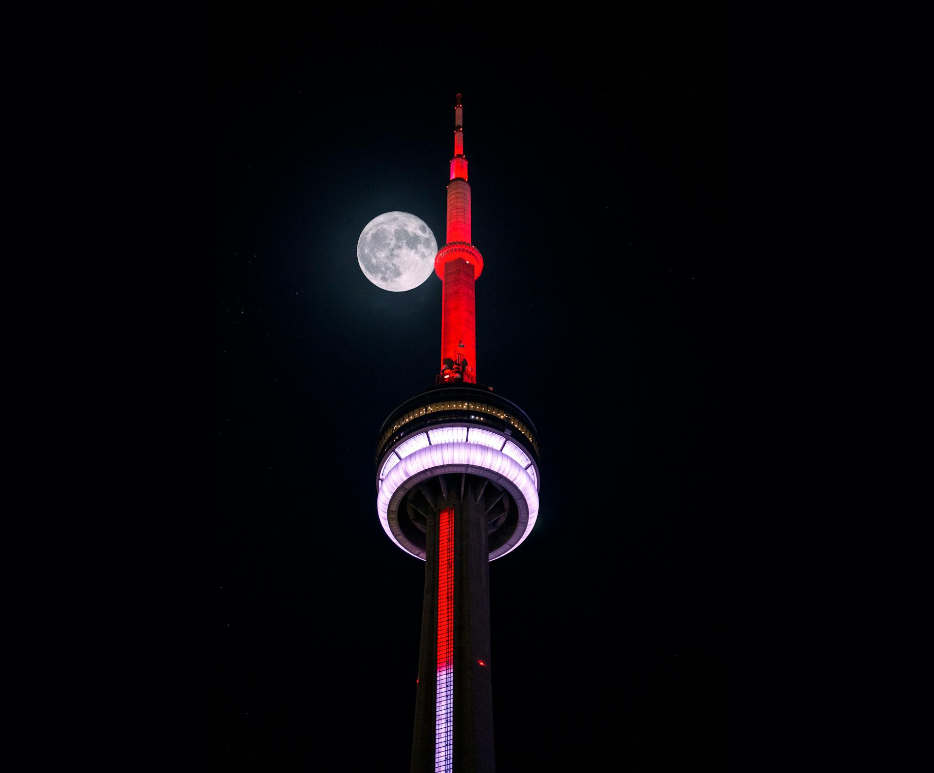CN Tower illuminated against the night sky