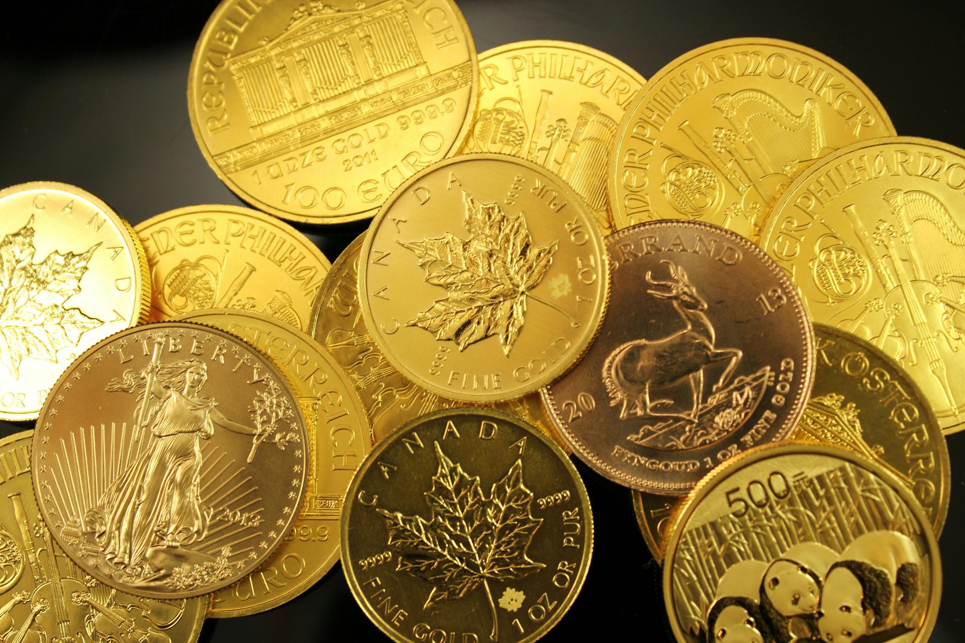 Several Canadian one-dollar coins (loonies) scattered on a flat surface