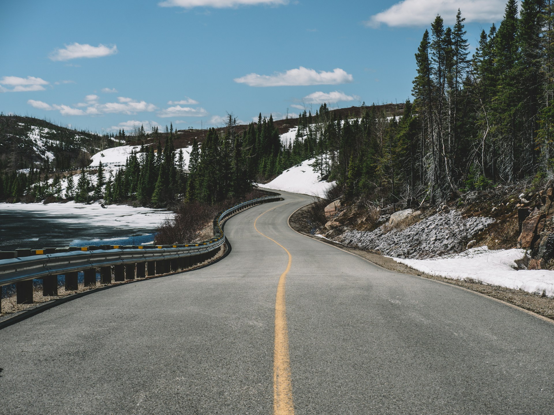 A quiet, empty road in Canada stretching into the distance