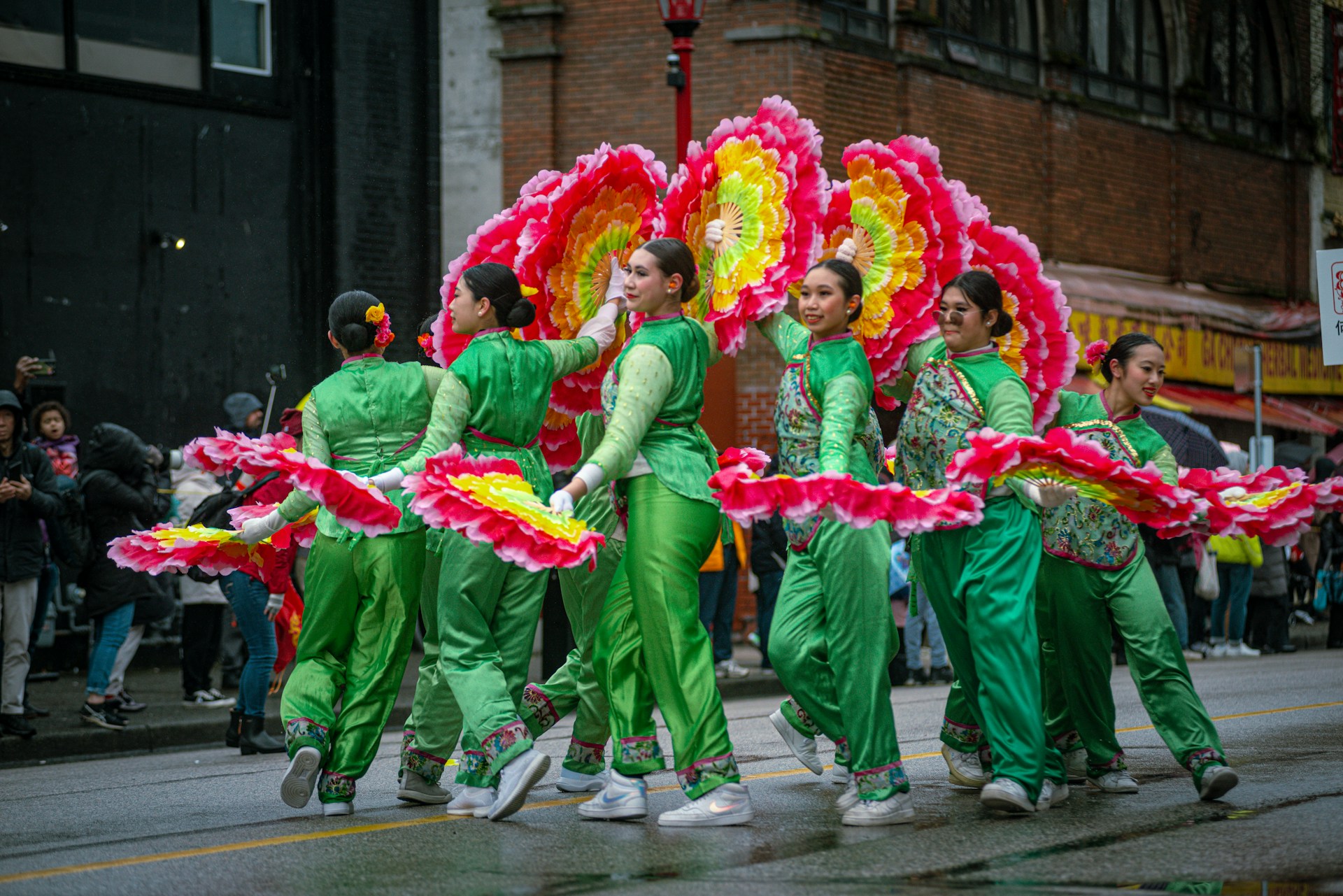 Performers dancing in colorful costumes during Chinese New Year celebrations in Vancouver.