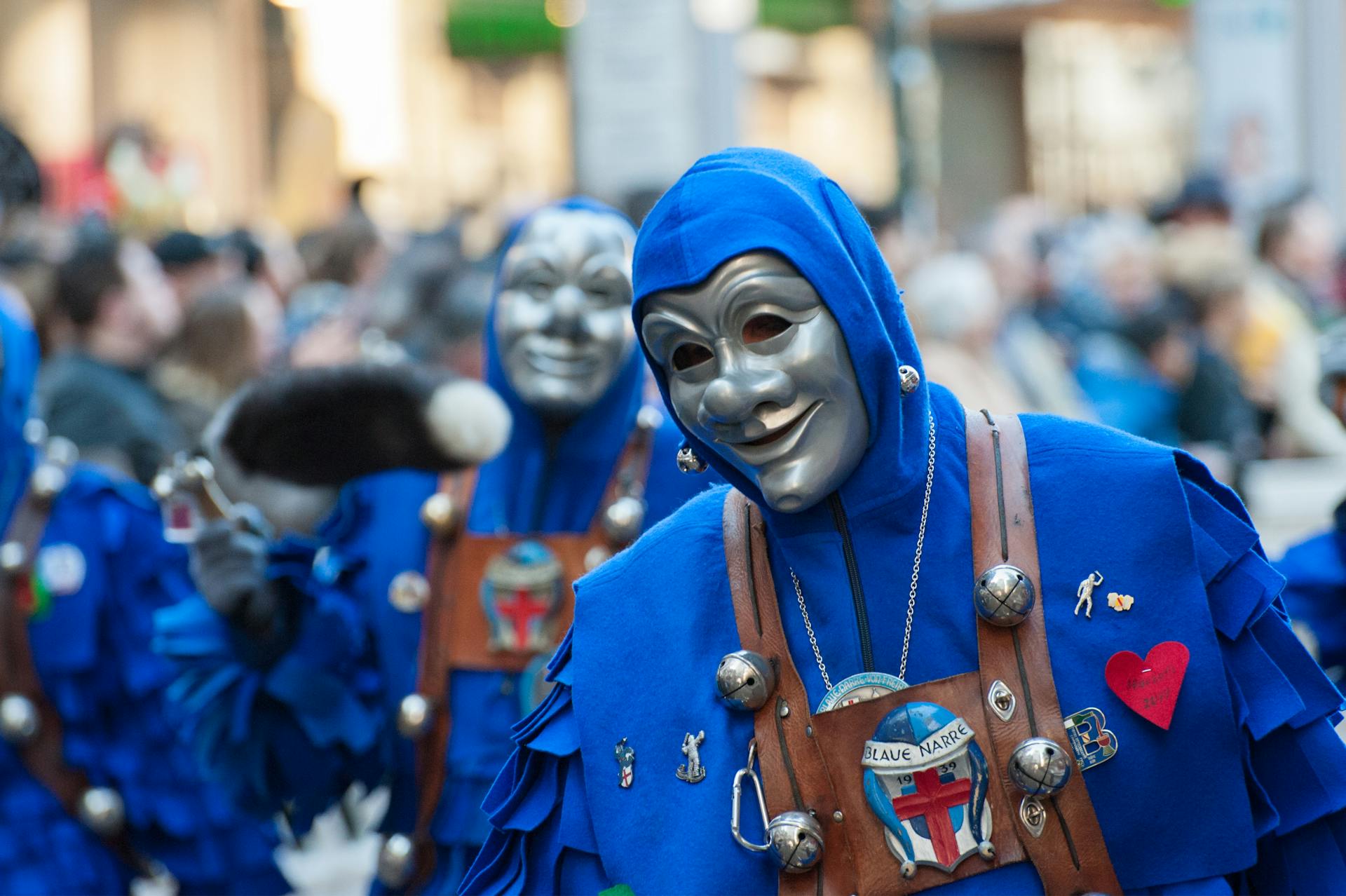 Group of people dressed in vibrant, humorous costumes celebrating Fasching outdoors.