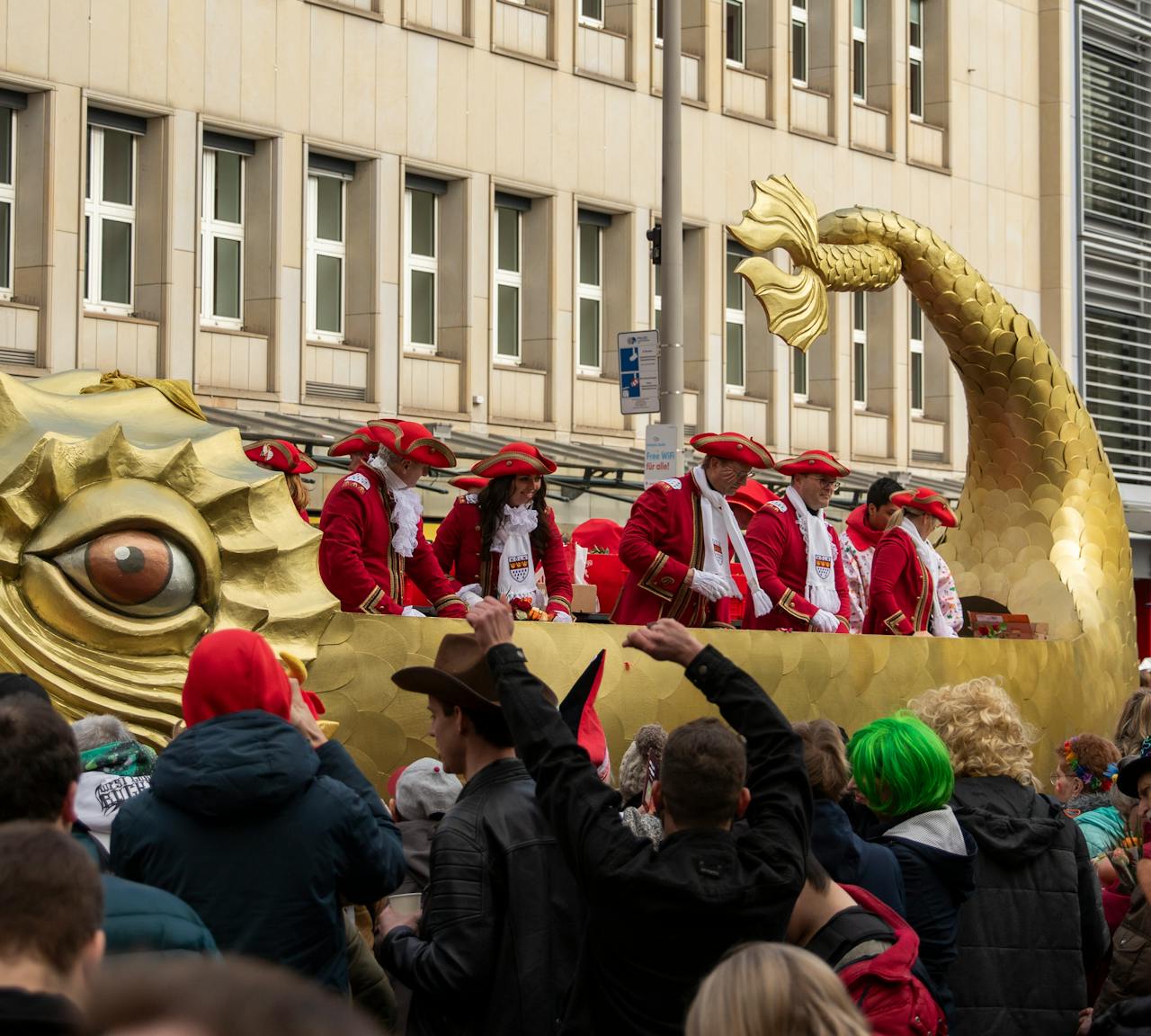 Massive crowds in Cologne city center celebrating Rosenmontag with floats and music.