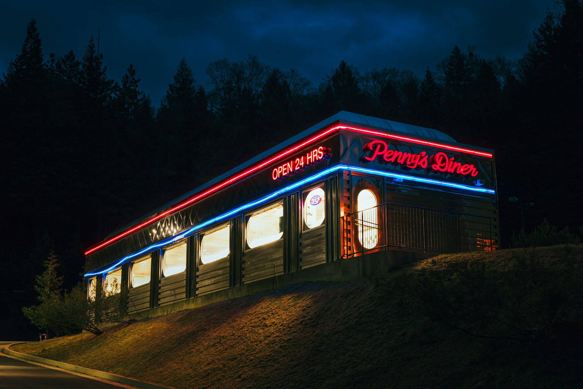 Classic American diner at night illuminated by vibrant neon lights 