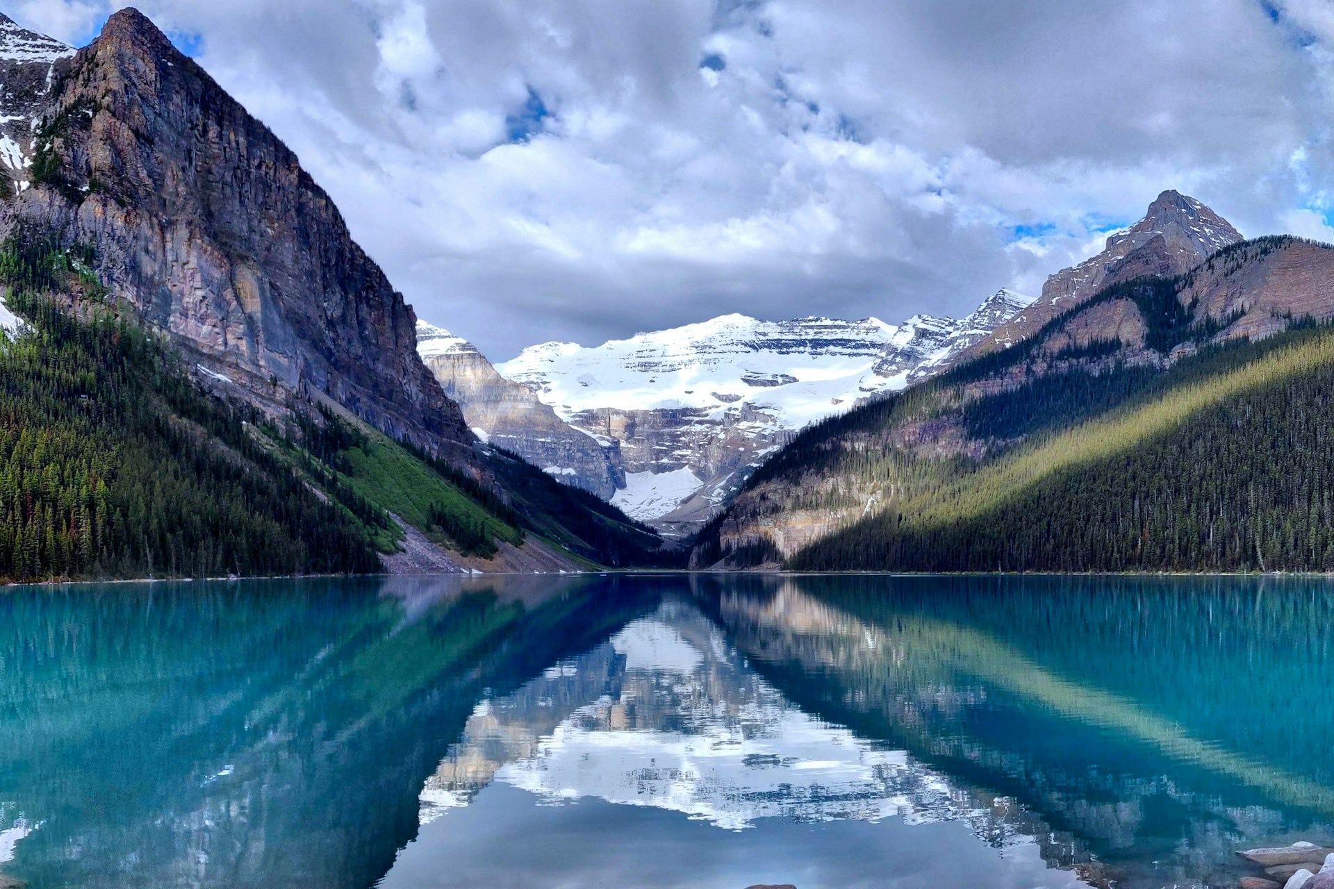 Turquoise waters of Lake Louise with mountain backdrop.