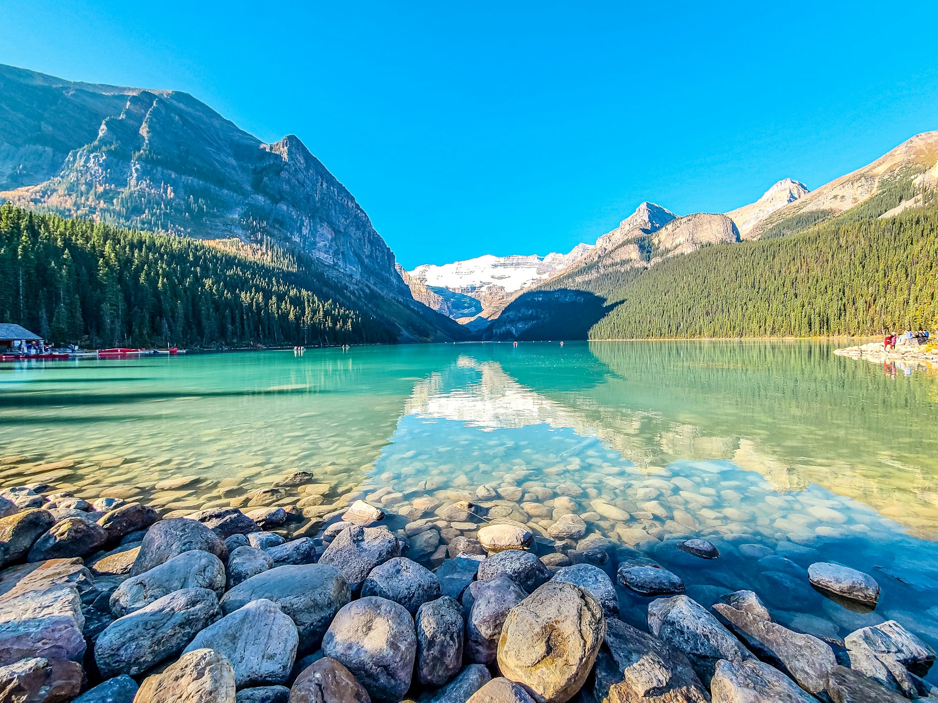 Turquoise waters of Lake Louise surrounded by towering mountains and glaciers in Banff National Park, Alberta.