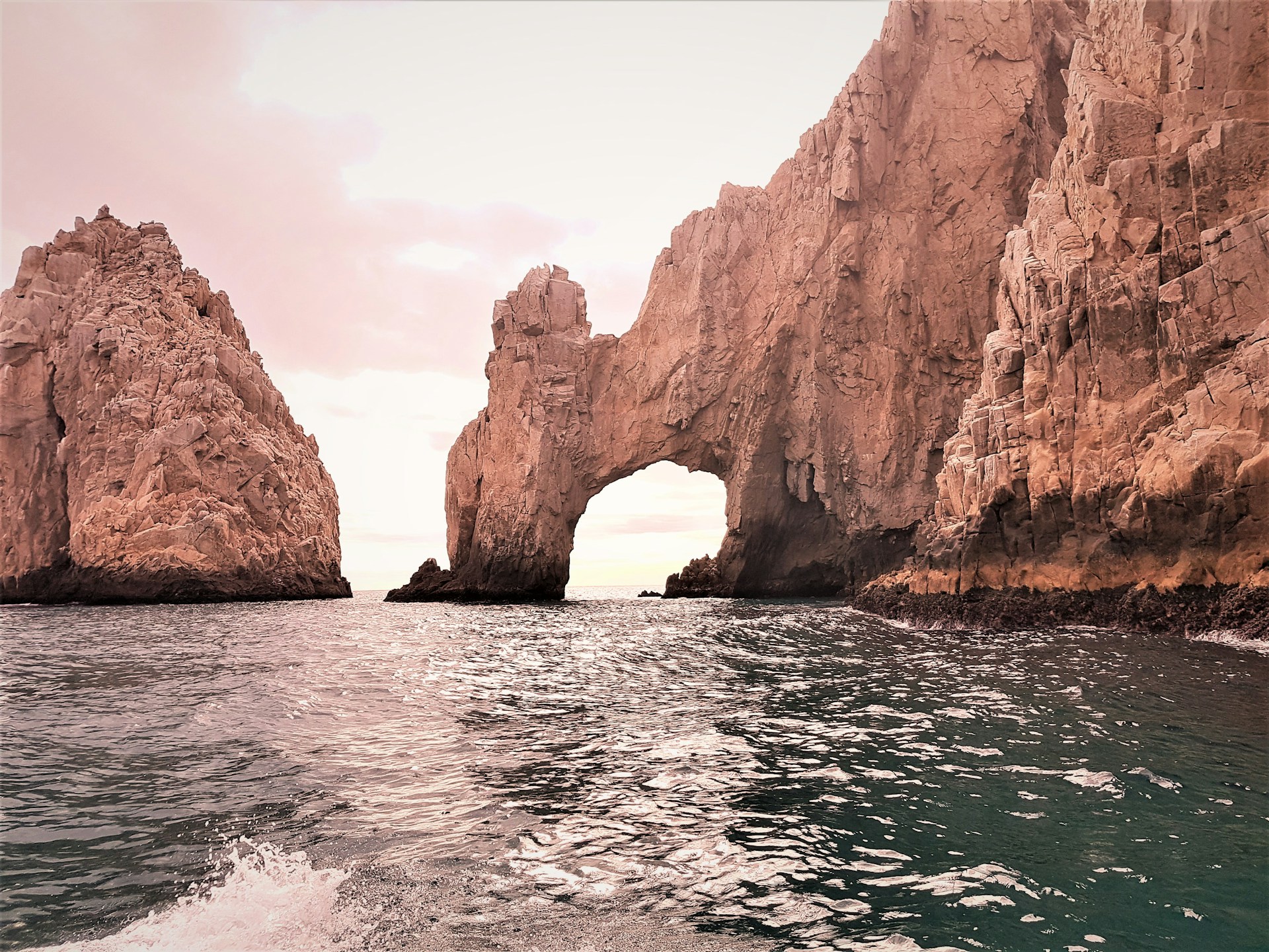 Dramatic rocky cliffs overlooking the deep blue Pacific Ocean in Los Cabos, Mexico