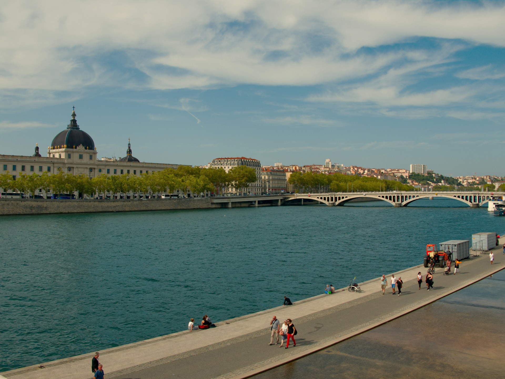 A scenic view of Lyon’s riverside promenade along the Rhône River
