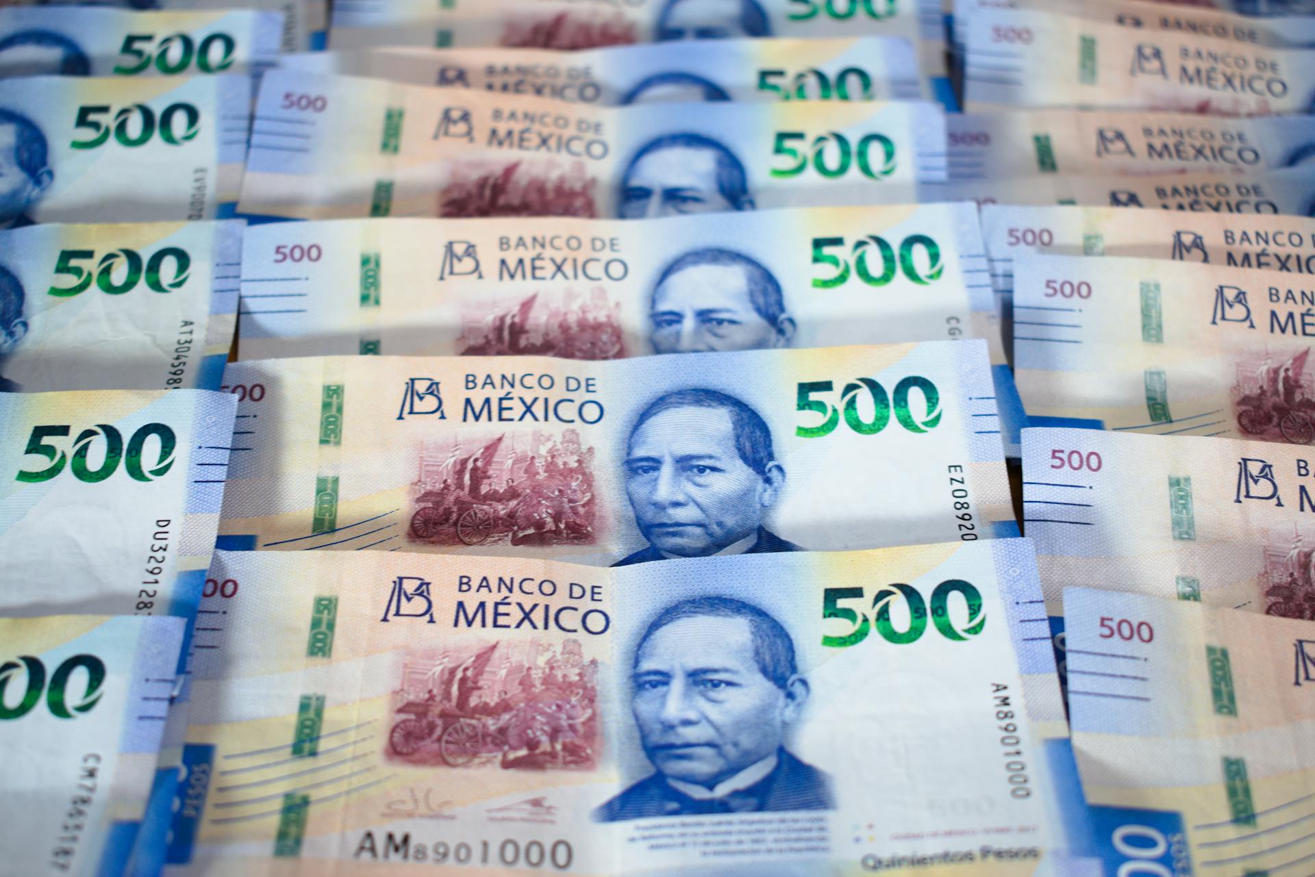 Various denominations of Mexican peso banknotes laid out,
