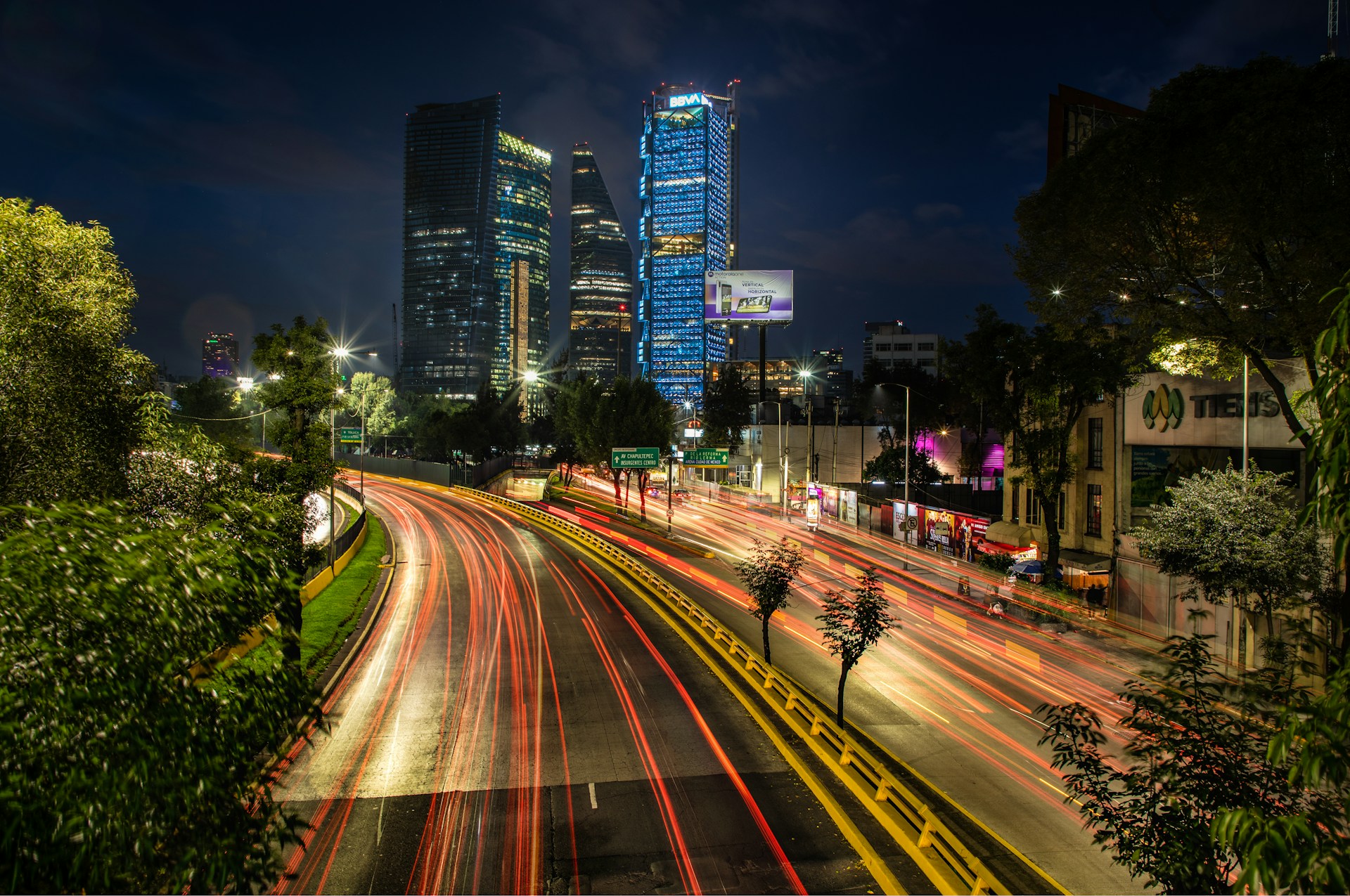 A quiet, empty road in Mexico City at night