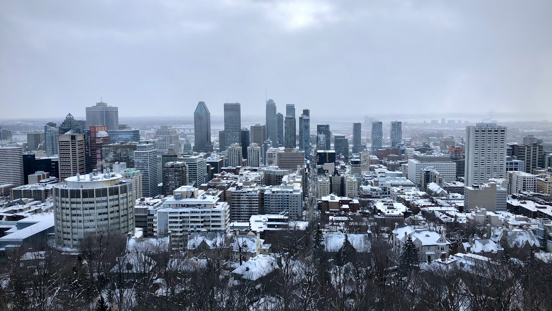 A Montreal skyscraper rises above the city on a snowy winter day