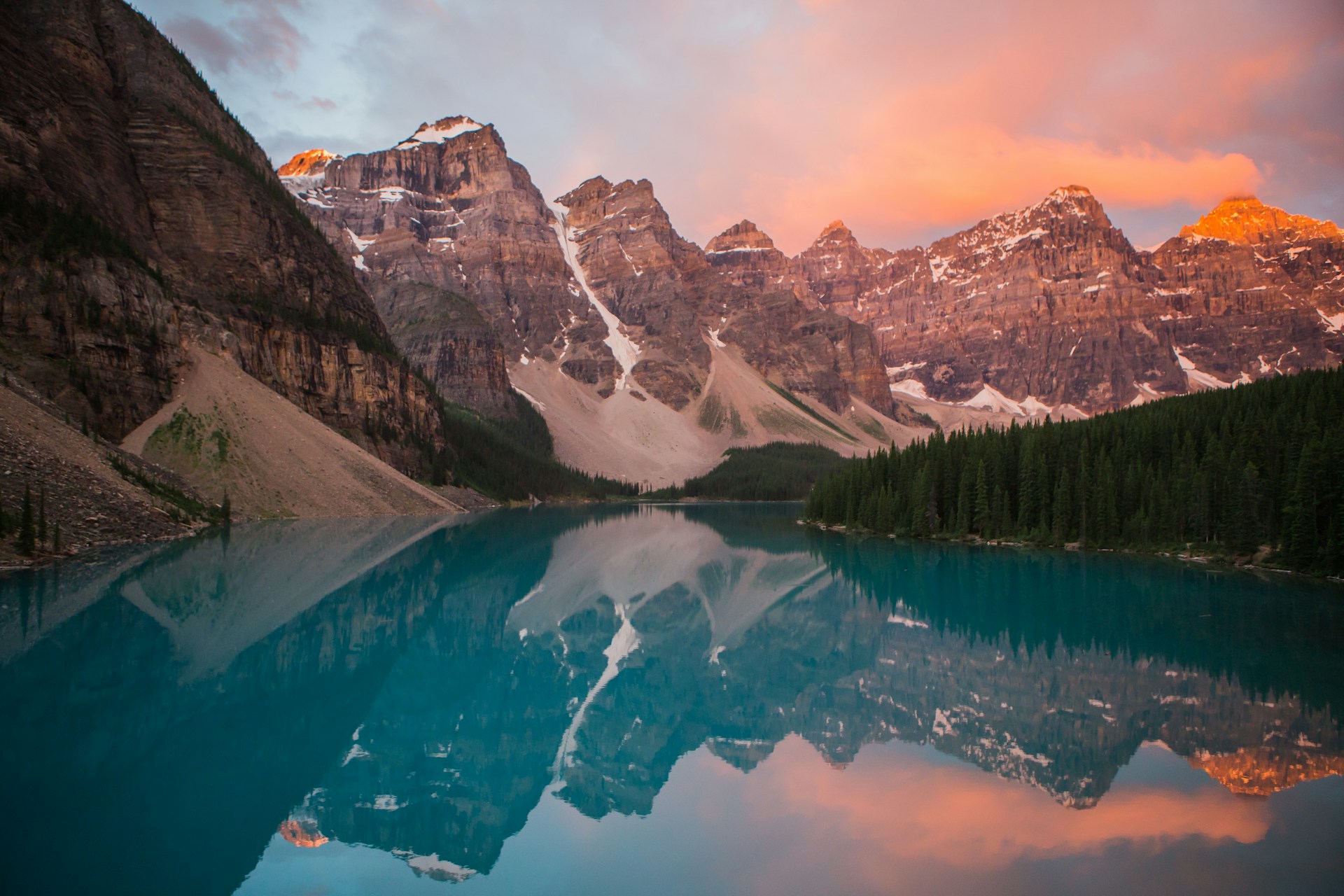 Vivid blue waters of Moraine Lake with towering mountain peaks in the background