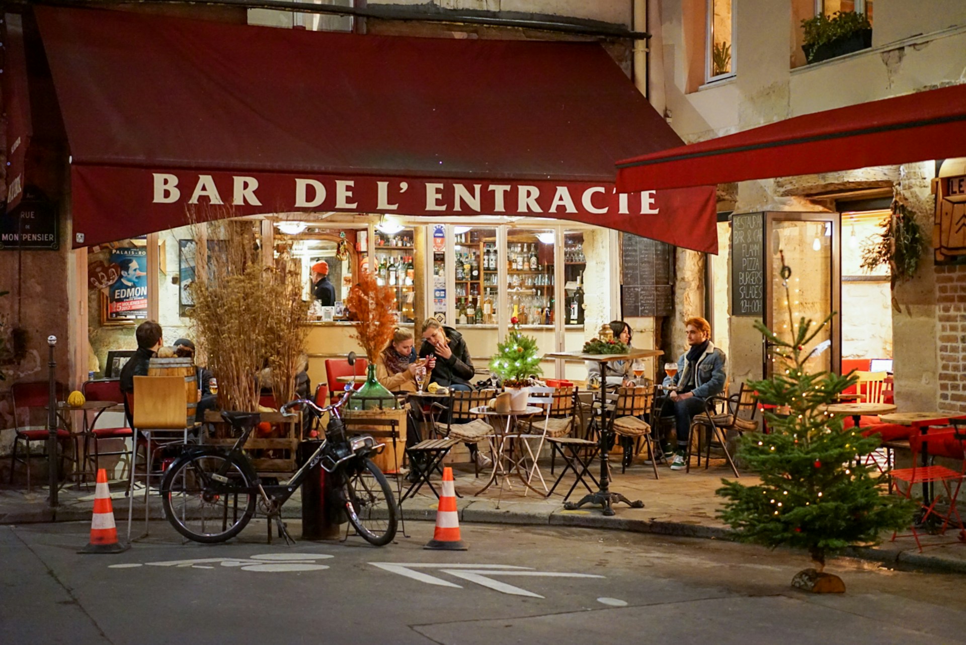 A vibrant Paris street bar lit up at night